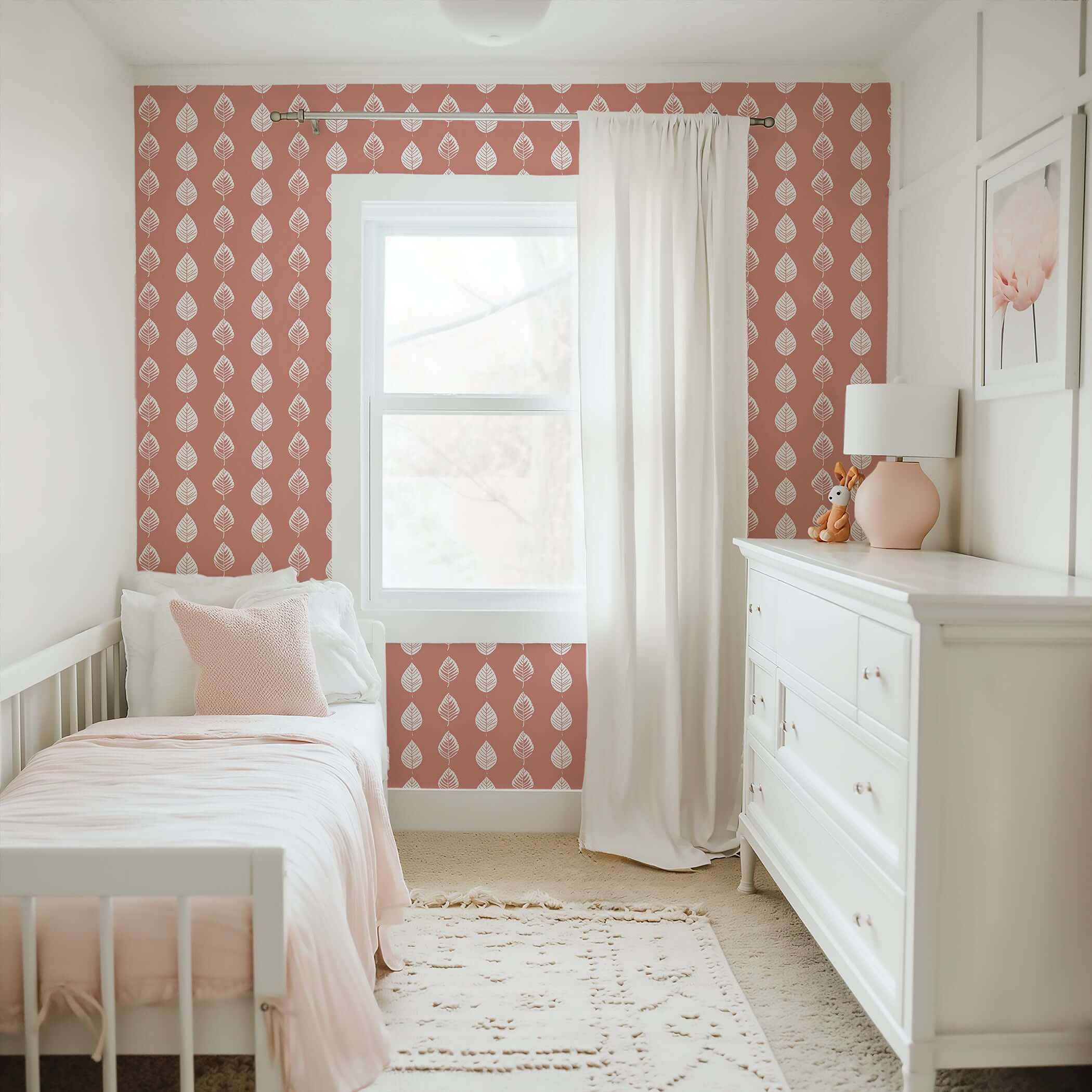 Petal Pink Wallpaper in nursery, featuring white leaf patterns on coral-pink background, ideal for modern children's playroom design.