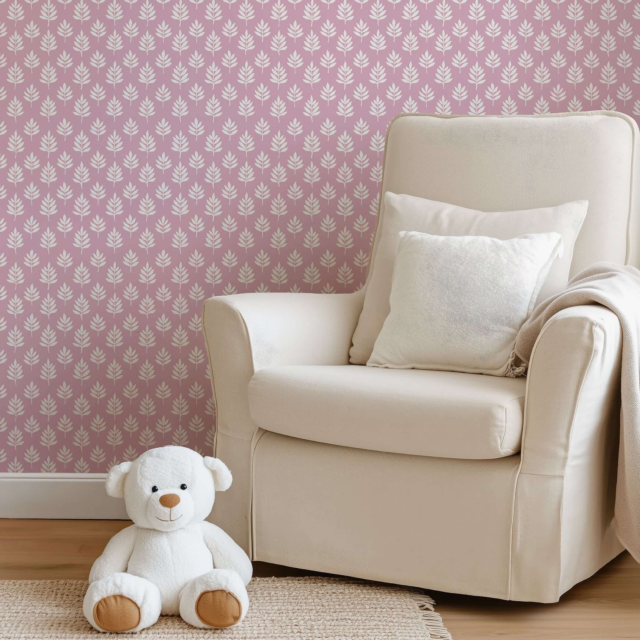 Gentle Leaves wallpaper with modern white leaf design on mauve-pink background, ideal for children's nursery or playroom décor.