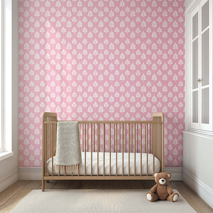 Modern nursery with Gentle Leaves wallpaper, featuring white leaf silhouettes on a mauve-pink background. Ideal for kids' rooms.
