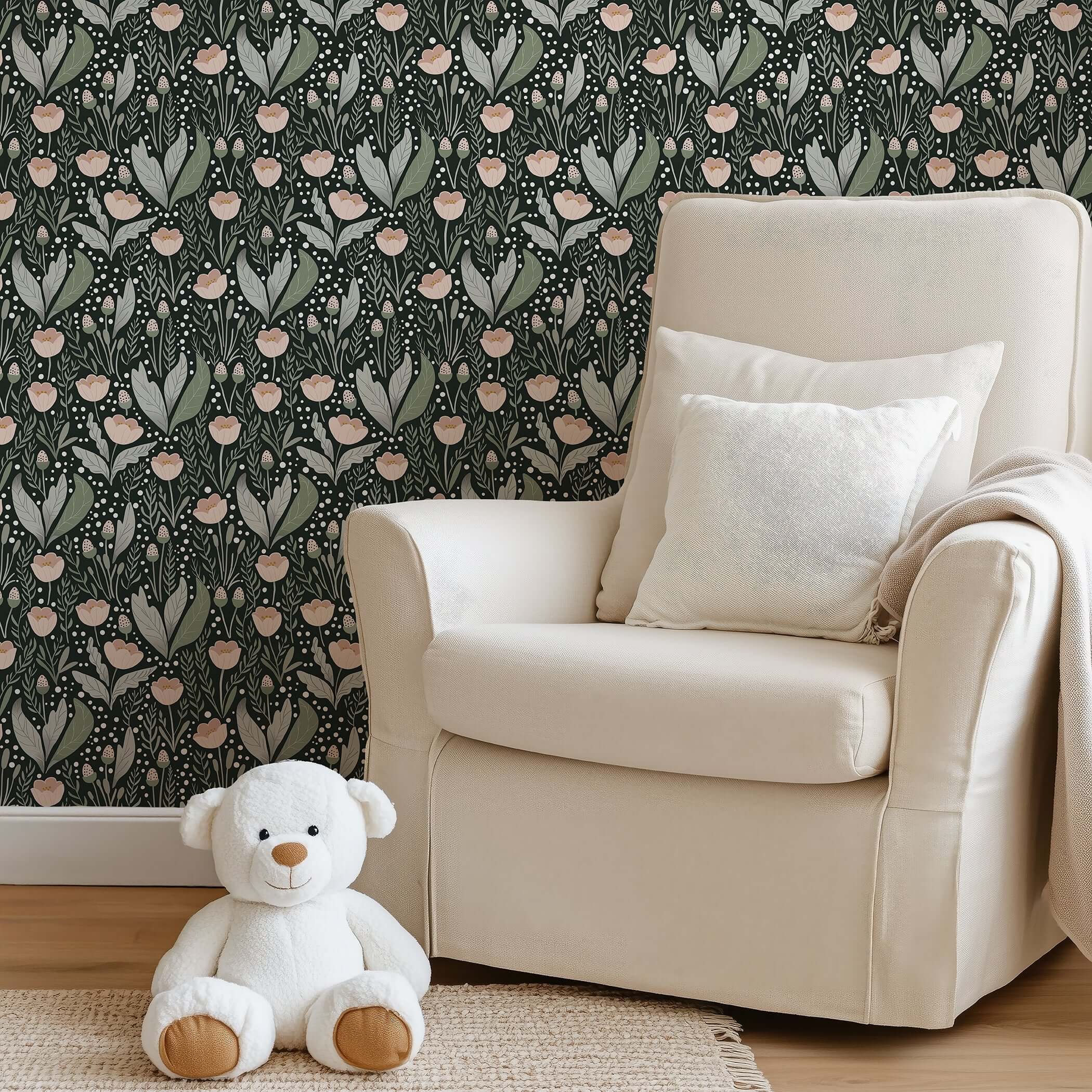 Cottagecore nursery with Secret Garden wallpaper, featuring pink flowers and foliage, cozy armchair, and teddy bear for a playful vibe.