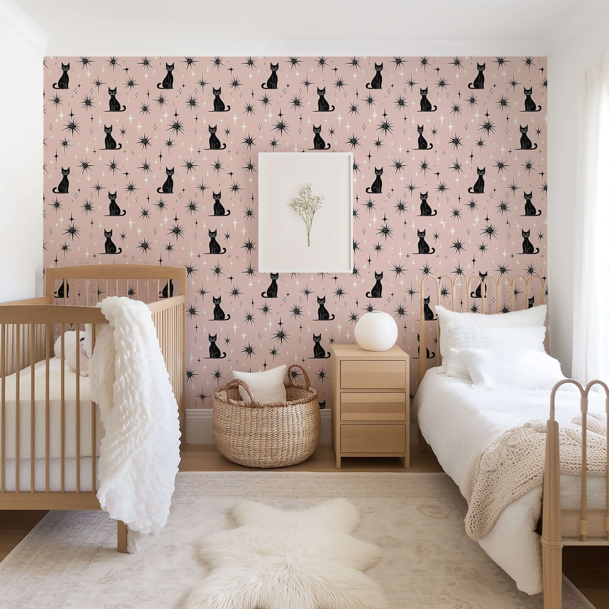 Twilight Catscape wallpaper with black cats and stars on blush backdrop in a modern nursery, perfect for mid-century playrooms.