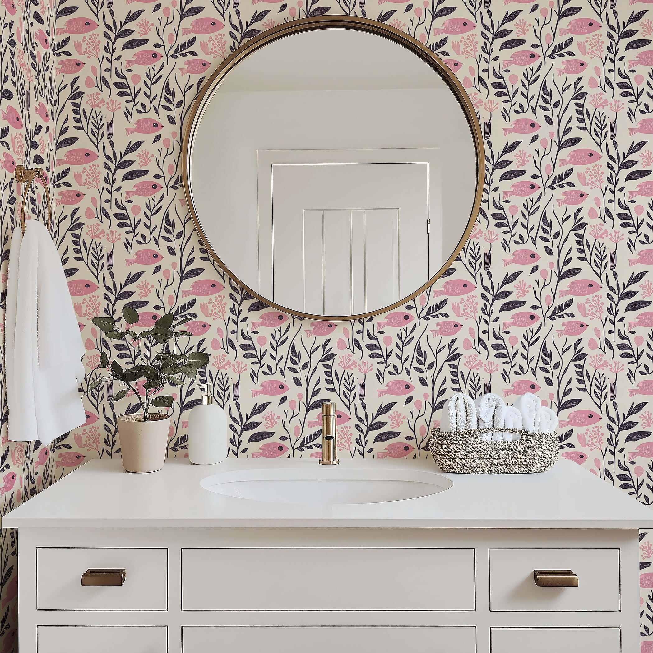 Vintage fish garden wallpaper with pink fish and floral design in a coastal bathroom setting, featuring a round mirror and white vanity.