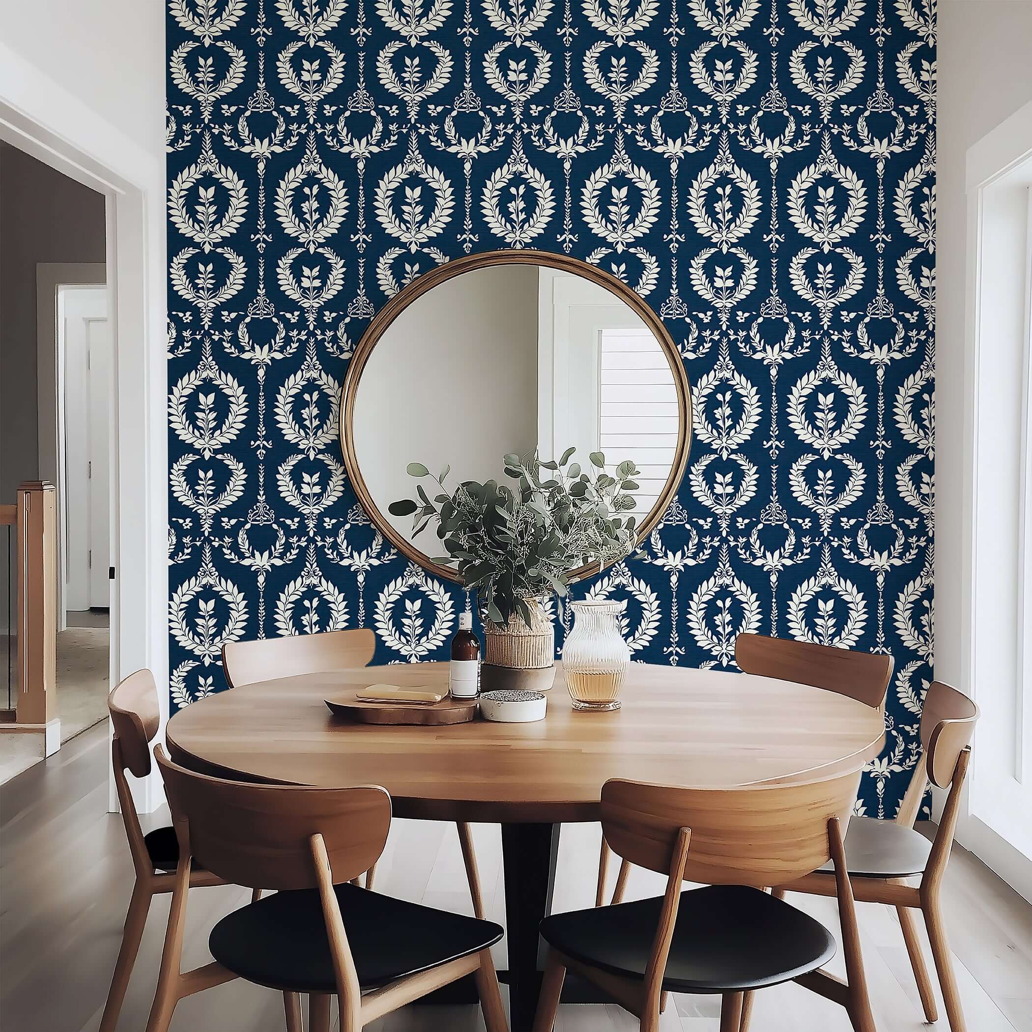 Nobility Wreath Wallpaper with ivory laurel patterns on navy, enhancing the traditional elegance of a modern dining room.