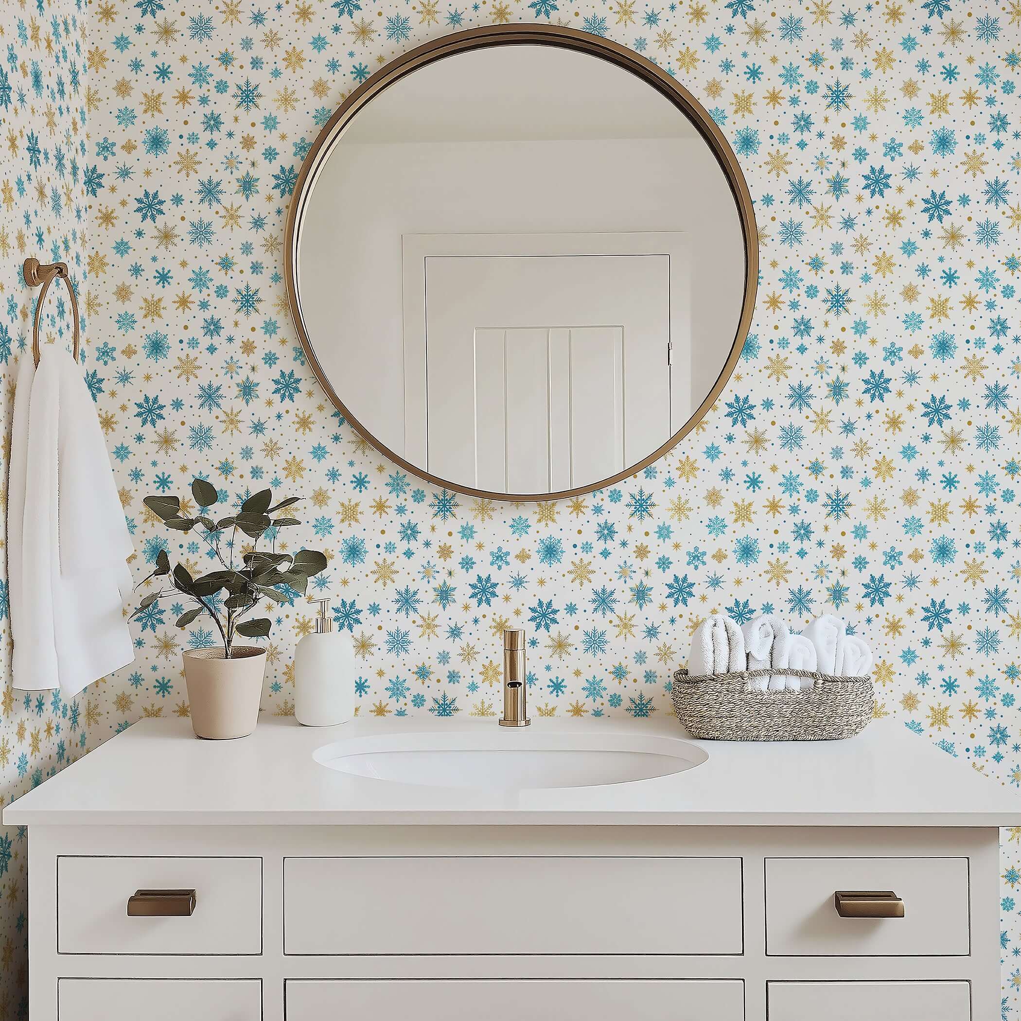 Mid-century modern bathroom with Golden Snowfall wallpaper featuring gold and blue snowflakes, round mirror, and white sink vanity.