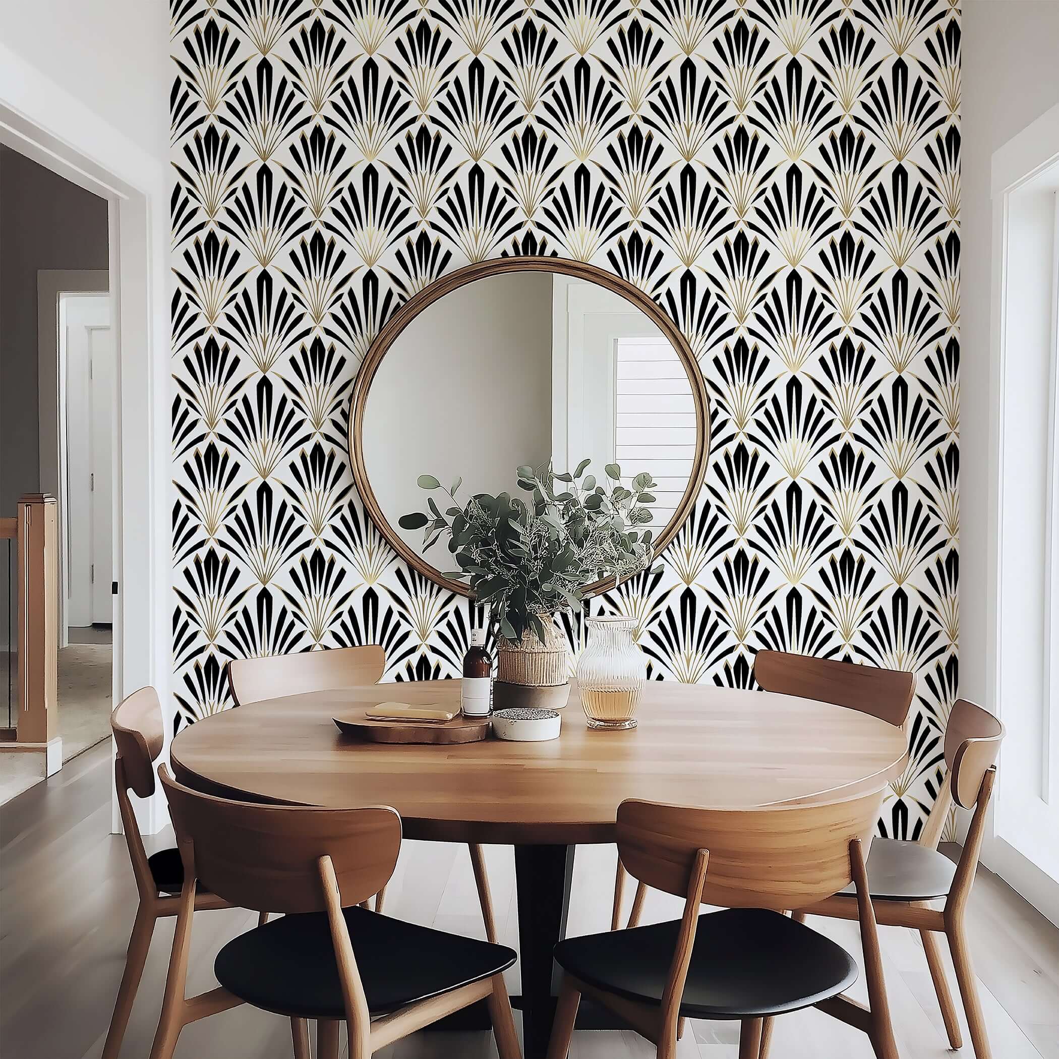 Round table in front of a wall with Deco Dynasty art deco geometric wallpaper featuring black, white, and gold fan motifs.
