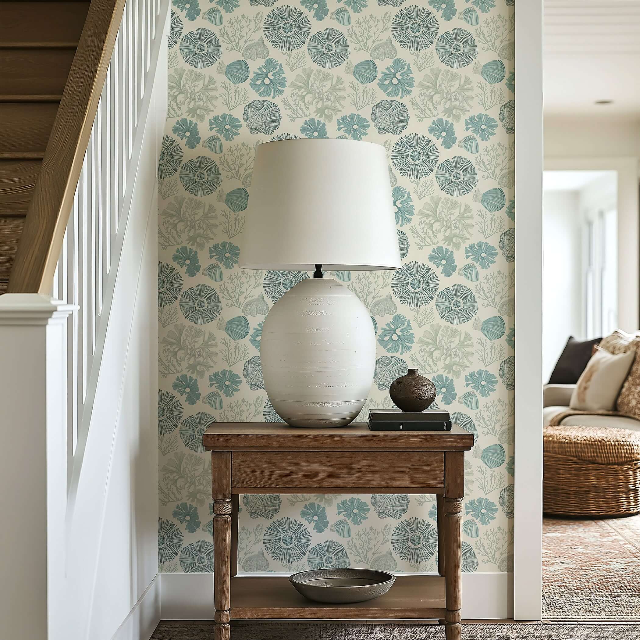 Elegant coastal wallpaper with seashell and coral design in soft blue tones, creating a serene beach atmosphere in a cozy room.