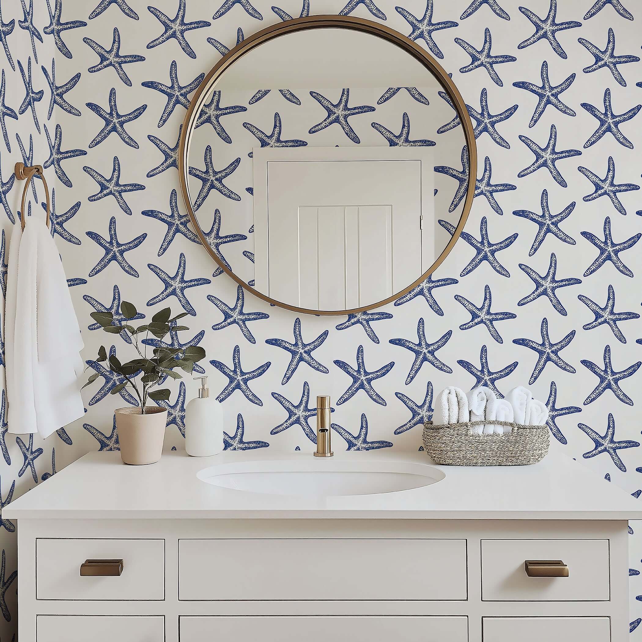 Bathroom with Seaside Stars wallpaper featuring blue starfish on white for a modern coastal beach design.