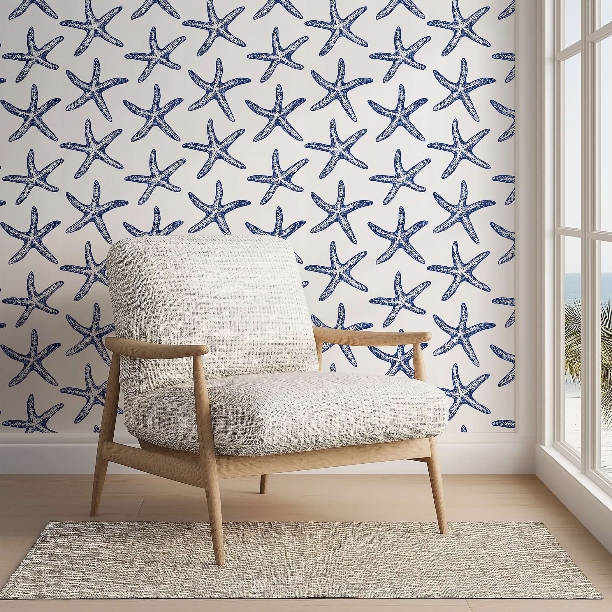 Modern coastal wallpaper featuring blue starfish on white background, perfect for beach-themed decor in bedrooms and living spaces.