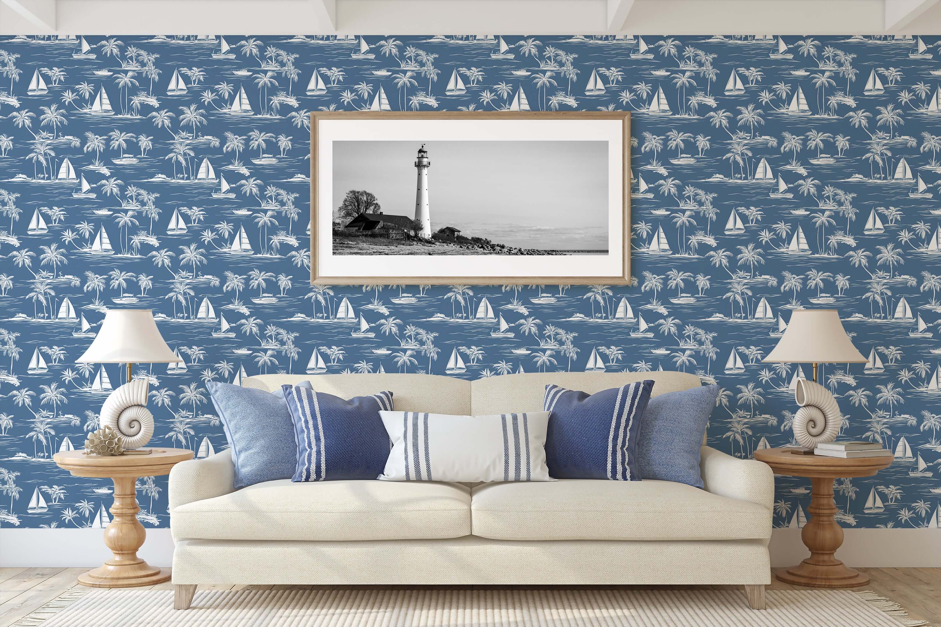 Coastal wallpaper with sailboats, palm trees, and beach motifs in toile style, featuring a serene blue background and nautical decor.
