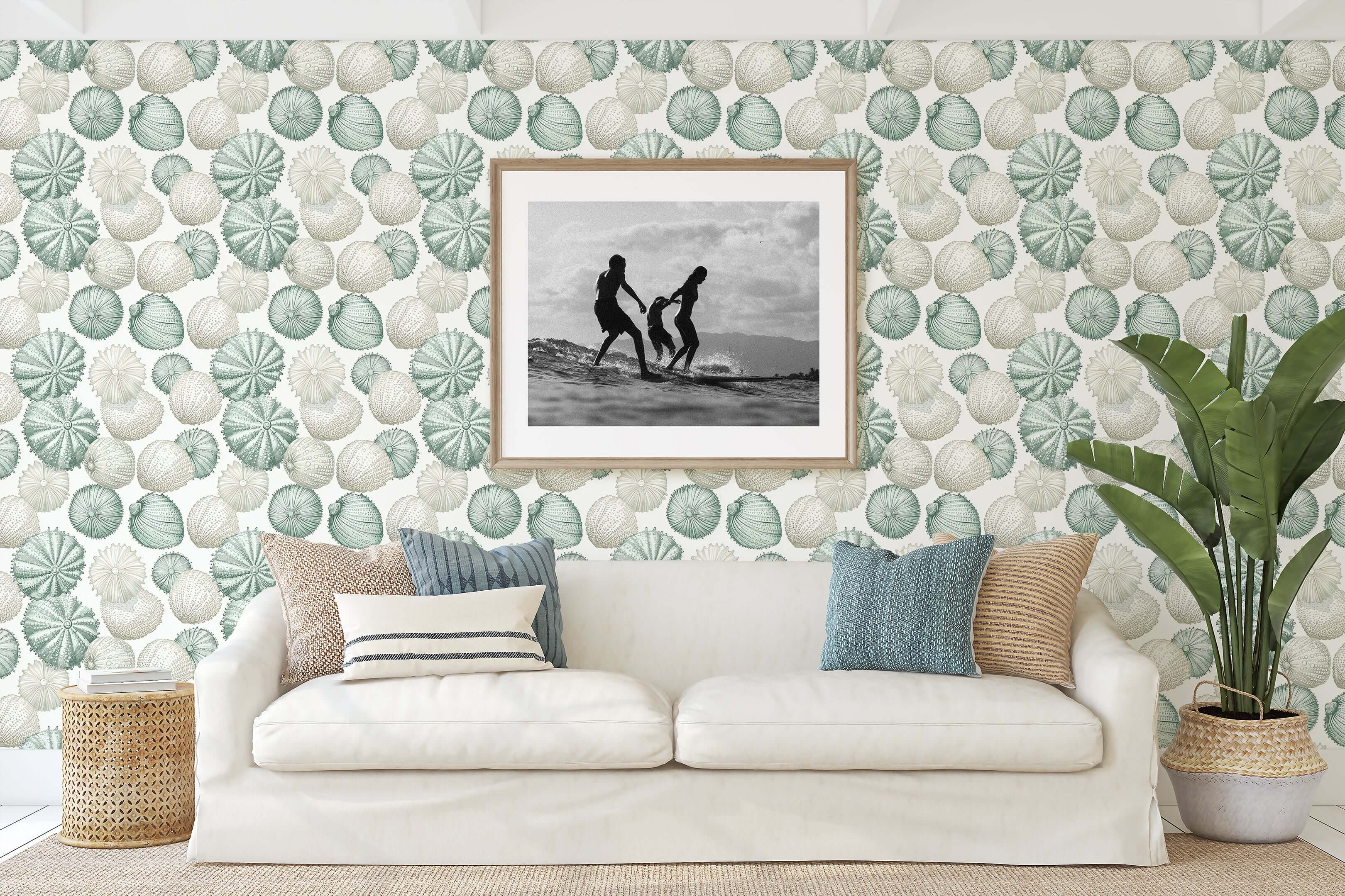 Elegant living room with 'Ocean Jewels' coastal wallpaper featuring sea urchins and seashells in soft green, cream, and blue tones.
