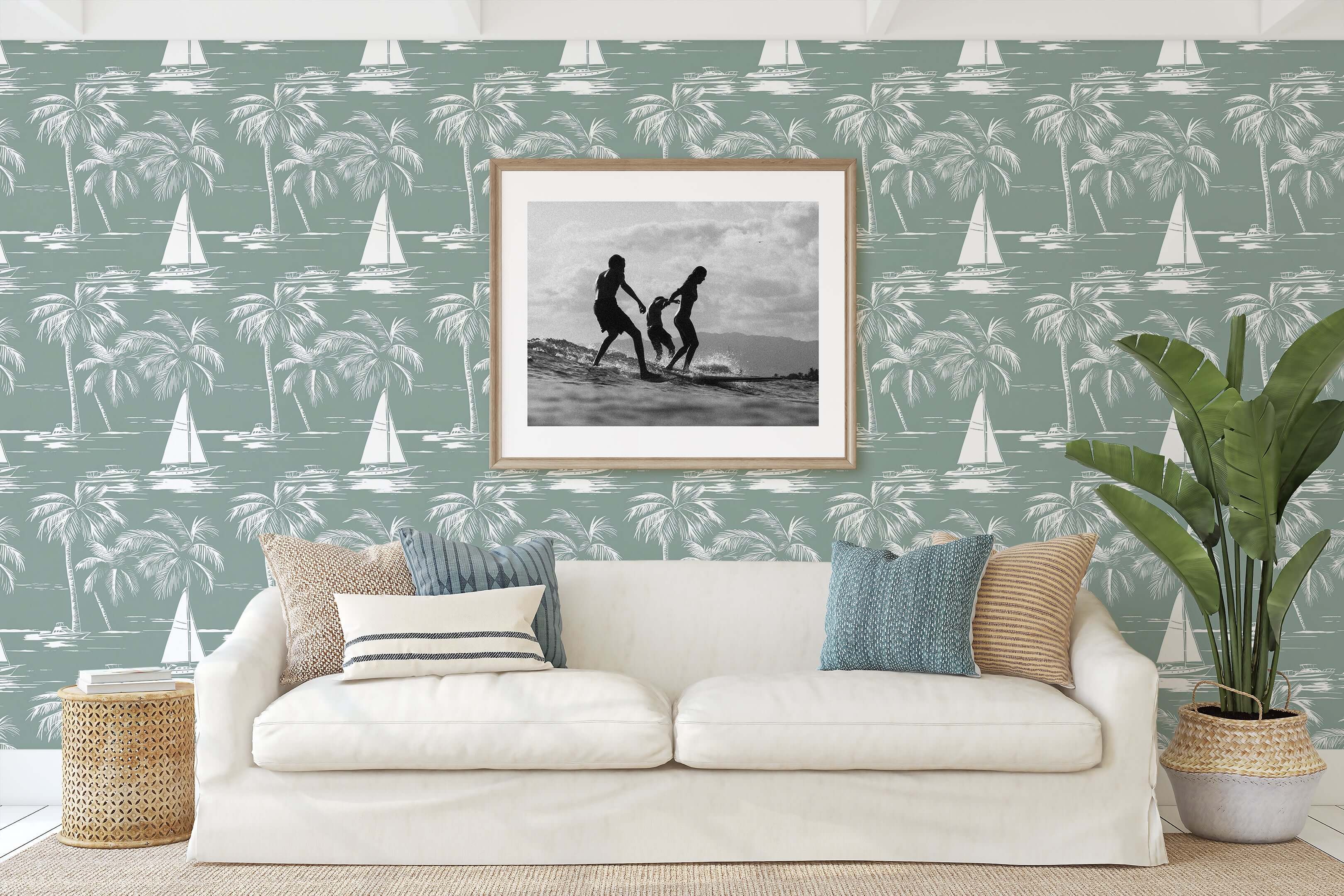 Living room with Harbor Escape wallpaper featuring sailboats, yachts, and palm trees in seafoam green, adding coastal and nautical vibes.