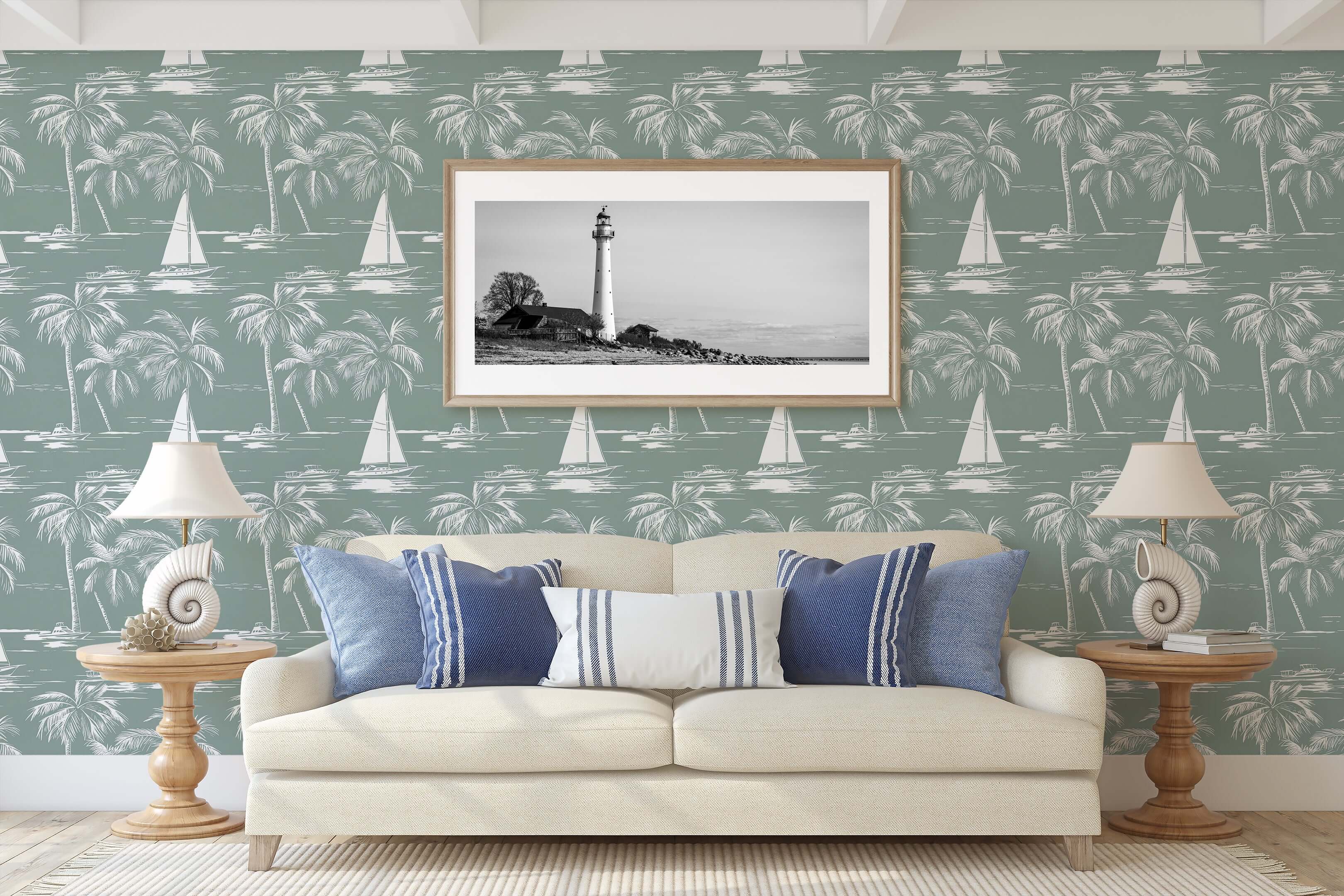 Seafoam green coastal wallpaper with sailboats and palm trees, enhancing a serene nautical-themed living room with a lighthouse artwork.