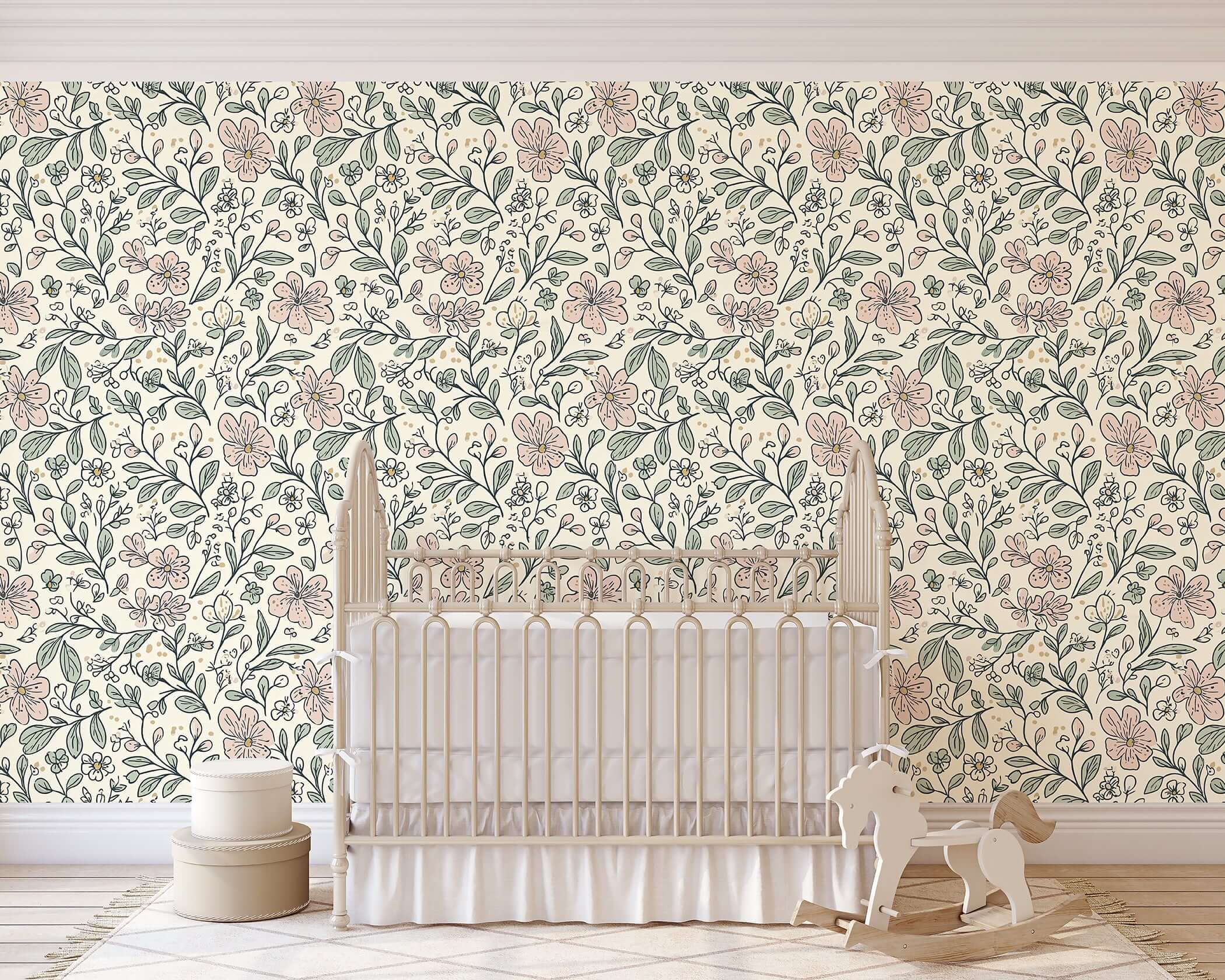 Nursery with 'Little Blossoms Garden' wallpaper featuring pink floral and leafy designs, perfect for a cottagecore baby room or playroom.
