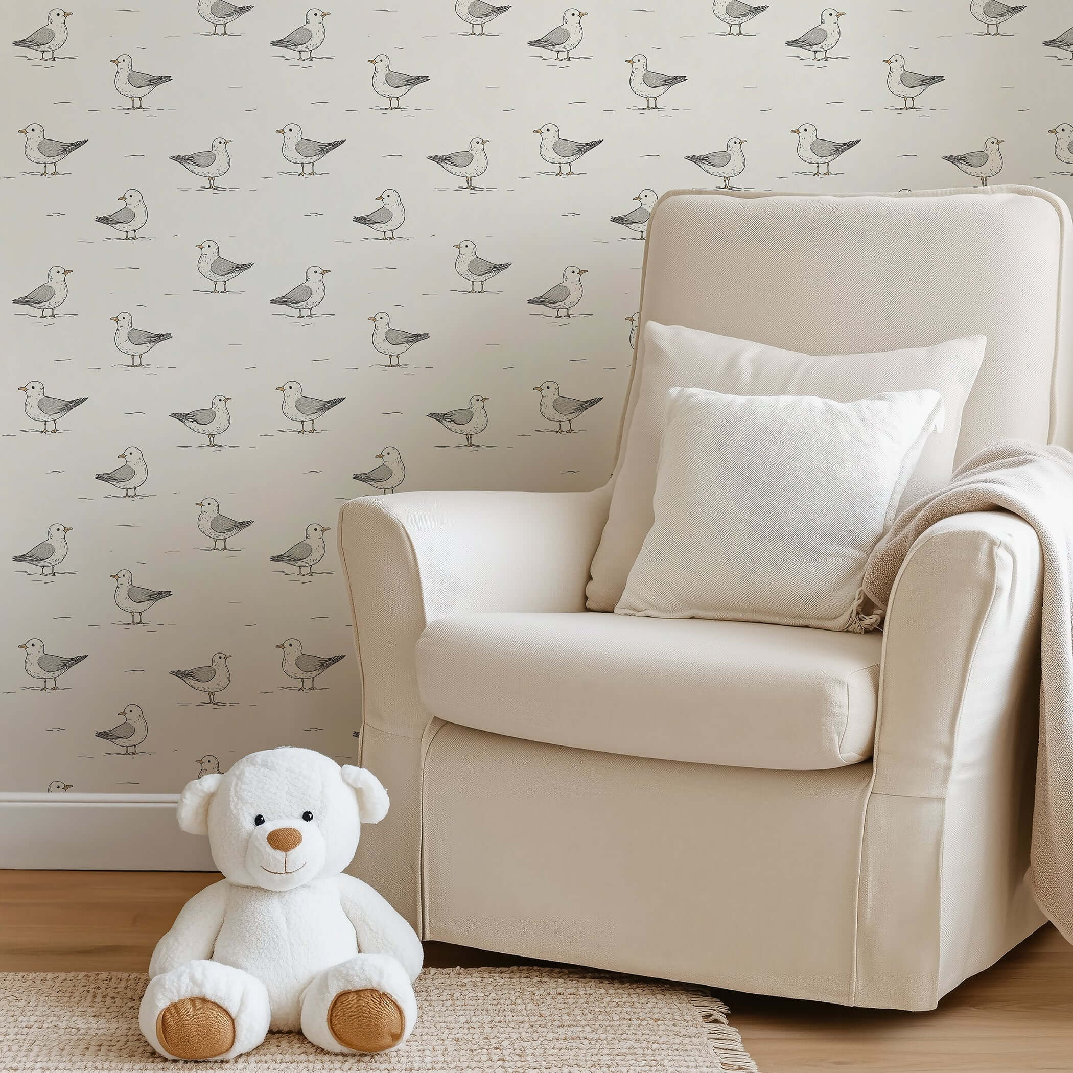 Playful seagull wallpaper in a cozy nursery with a cream armchair and teddy bear, perfect for children's rooms and modern design.