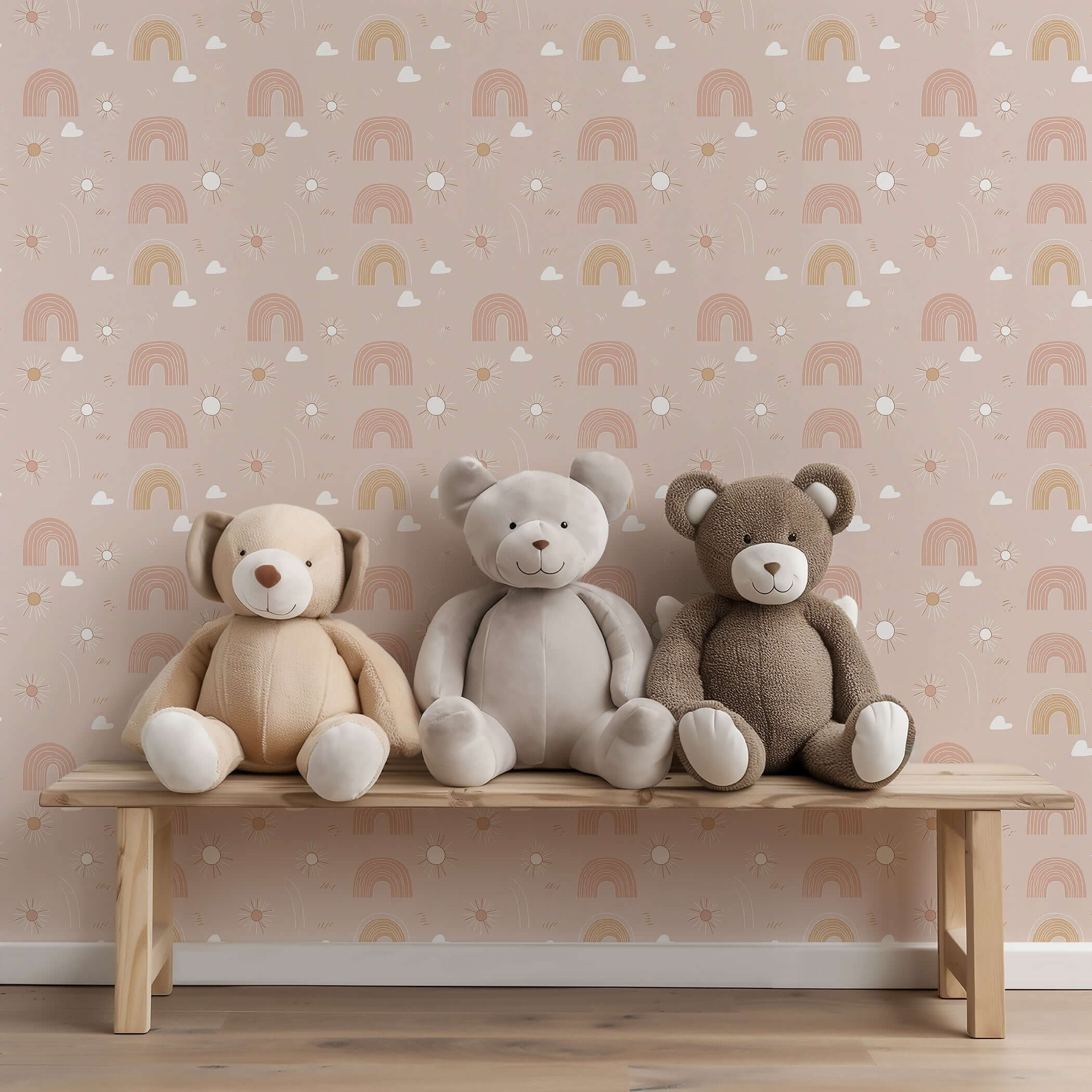 Three plush bears sit on a bench against pink Dreamy Rainbows wallpaper, perfect for modern nurseries and playrooms.