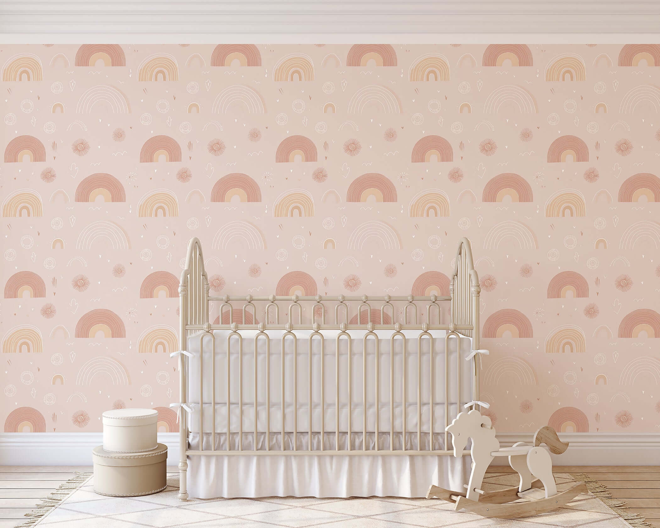 Pastel Rainbow Delight Wallpaper in pink hues adds modern whimsy to nursery decor with hand-drawn rainbows and sunbursts.