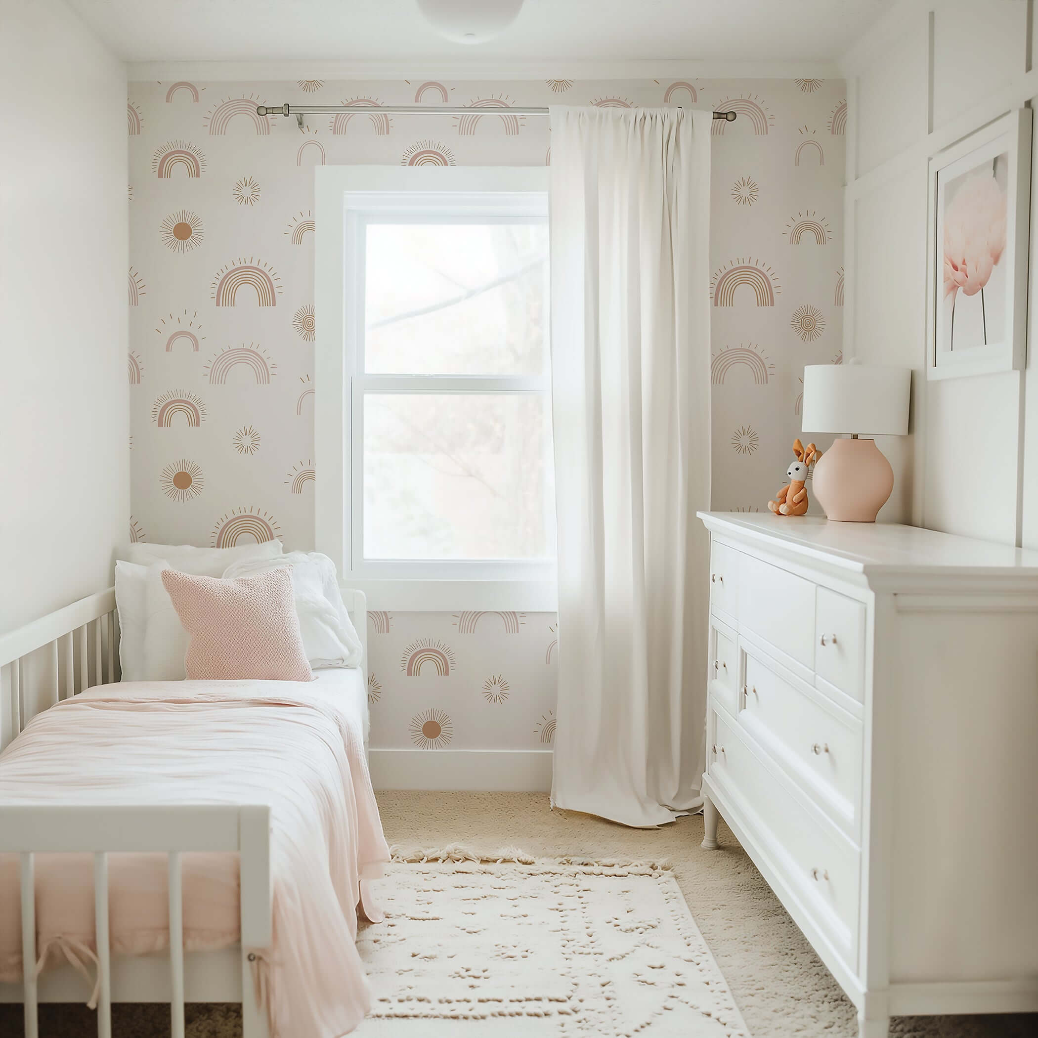 Cozy nursery with Sunshine and Rainbows wallpaper featuring hand-drawn rainbows and suns for a modern, playful and uplifting atmosphere.