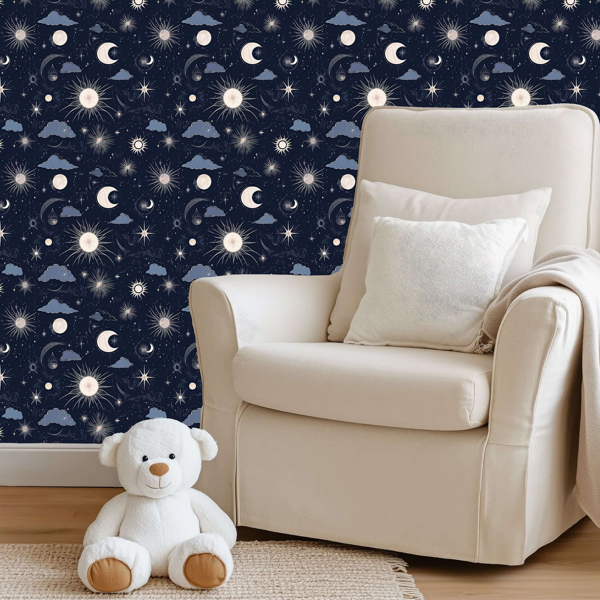 Cozy nursery with 'Night and Lullaby' wallpaper featuring navy skies, crescent moons, stars, clouds, and a plush teddy bear.