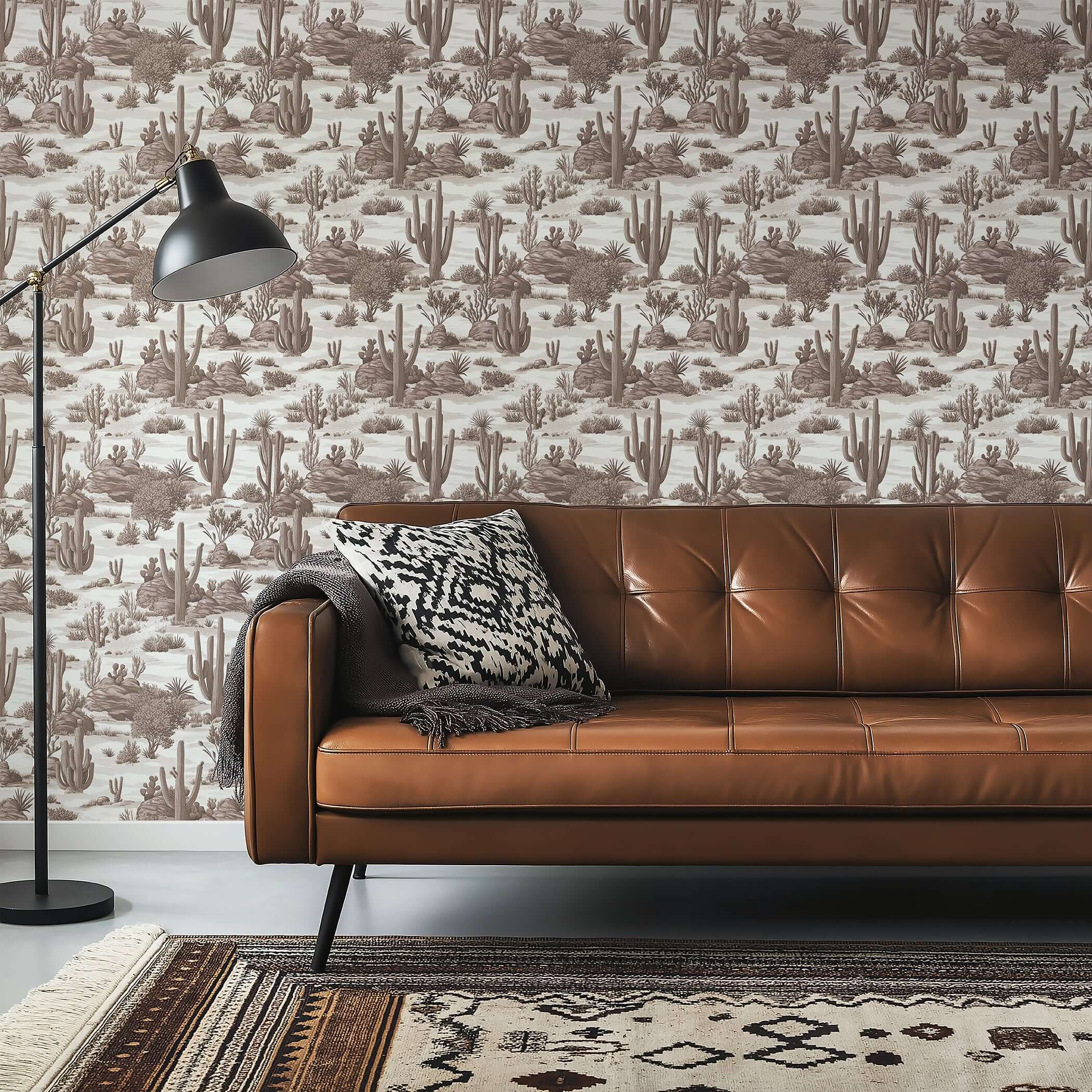 Desert Toile Elegance II wallpaper featuring cacti in a toile design, with a brown leather sofa and vintage lamp in a modern setting.