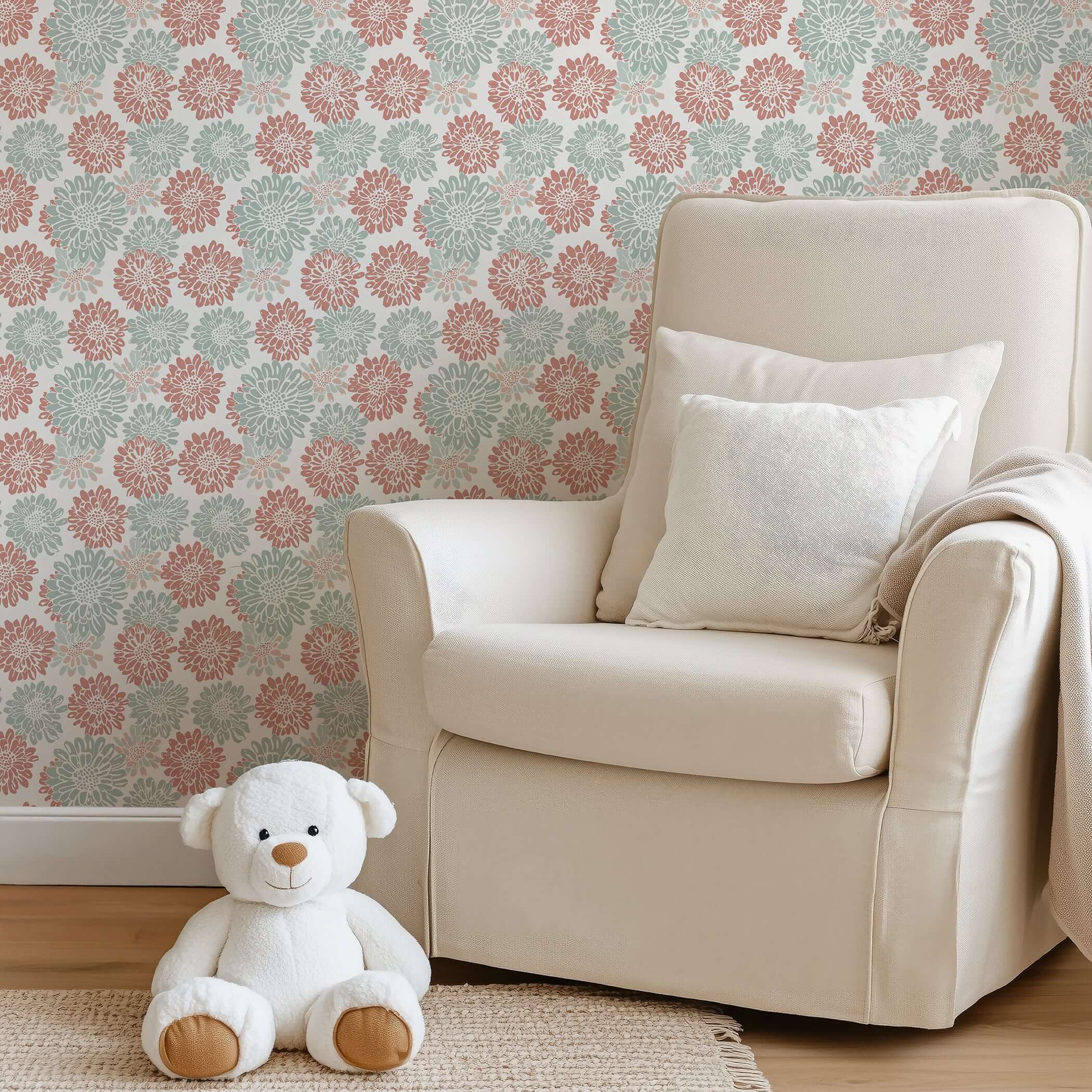Room with Playful Dahlia Parade wallpaper featuring pink and teal dahlia flowers on a white background, plush chair, and teddy bear.