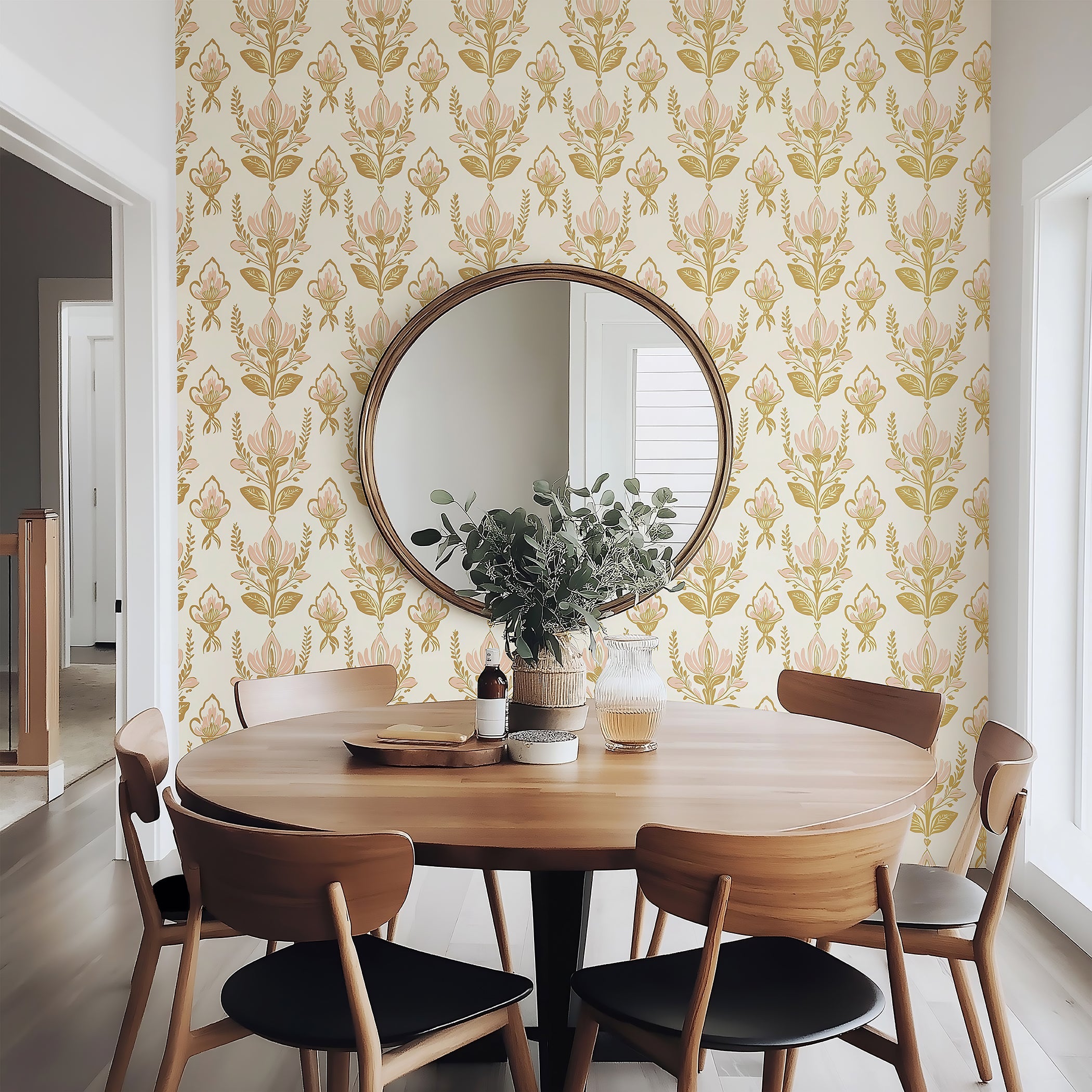 Dining room with Vintage Floral Bouquet wallpaper in pink and gold tones, featuring a round mirror and wooden dining set.