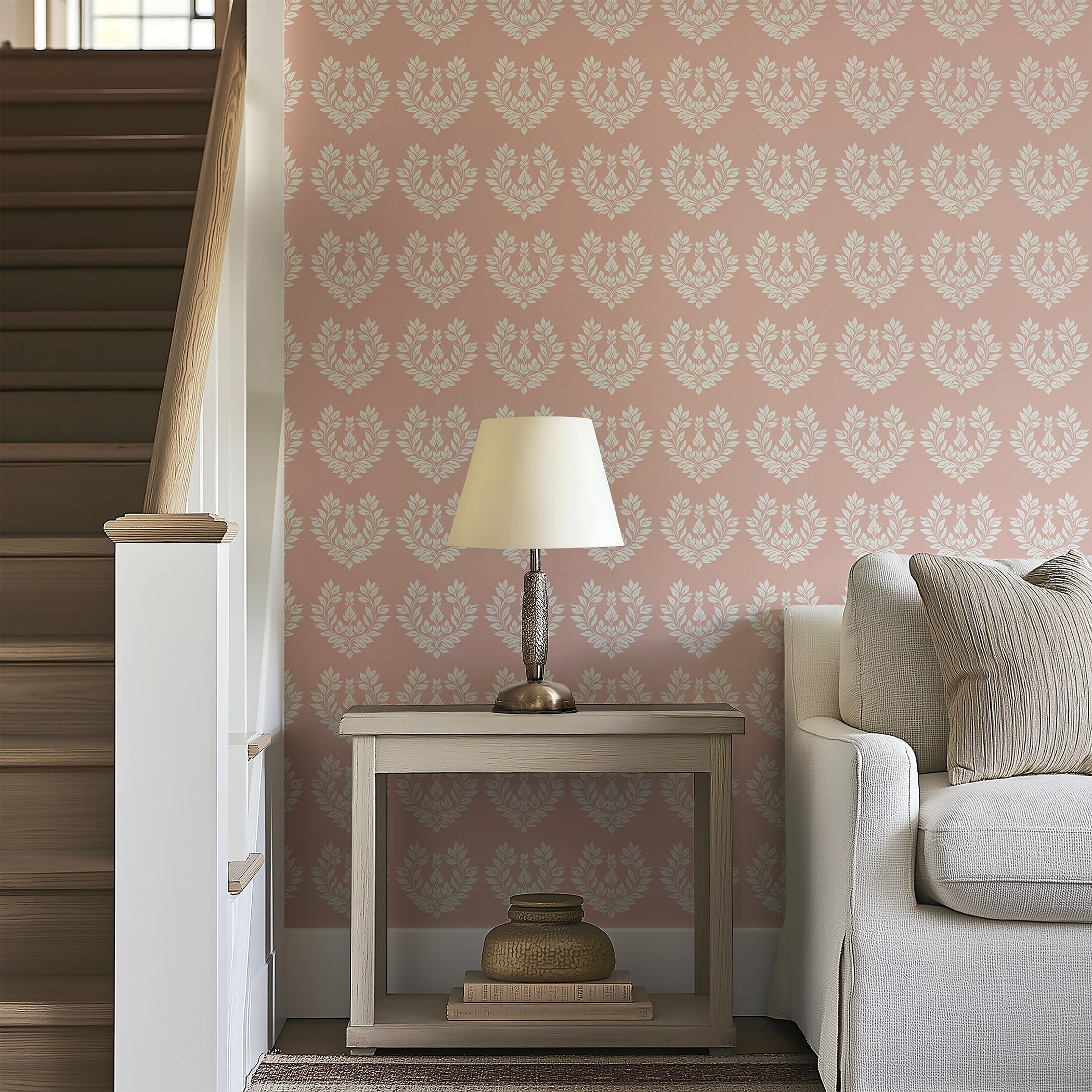 Romantic flora design wallpaper with white laurels on blush-pink background, enhancing a cozy living space with elegance.