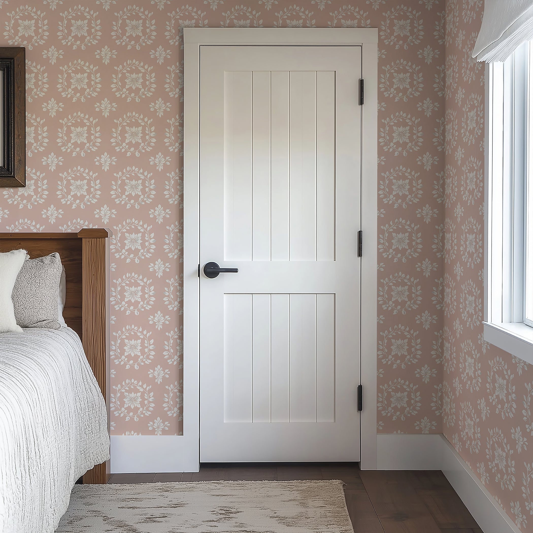 Bedroom interior featuring 'Delicate Floral Embrace' wallpaper with floral wreaths in ivory and gray on a blush background.