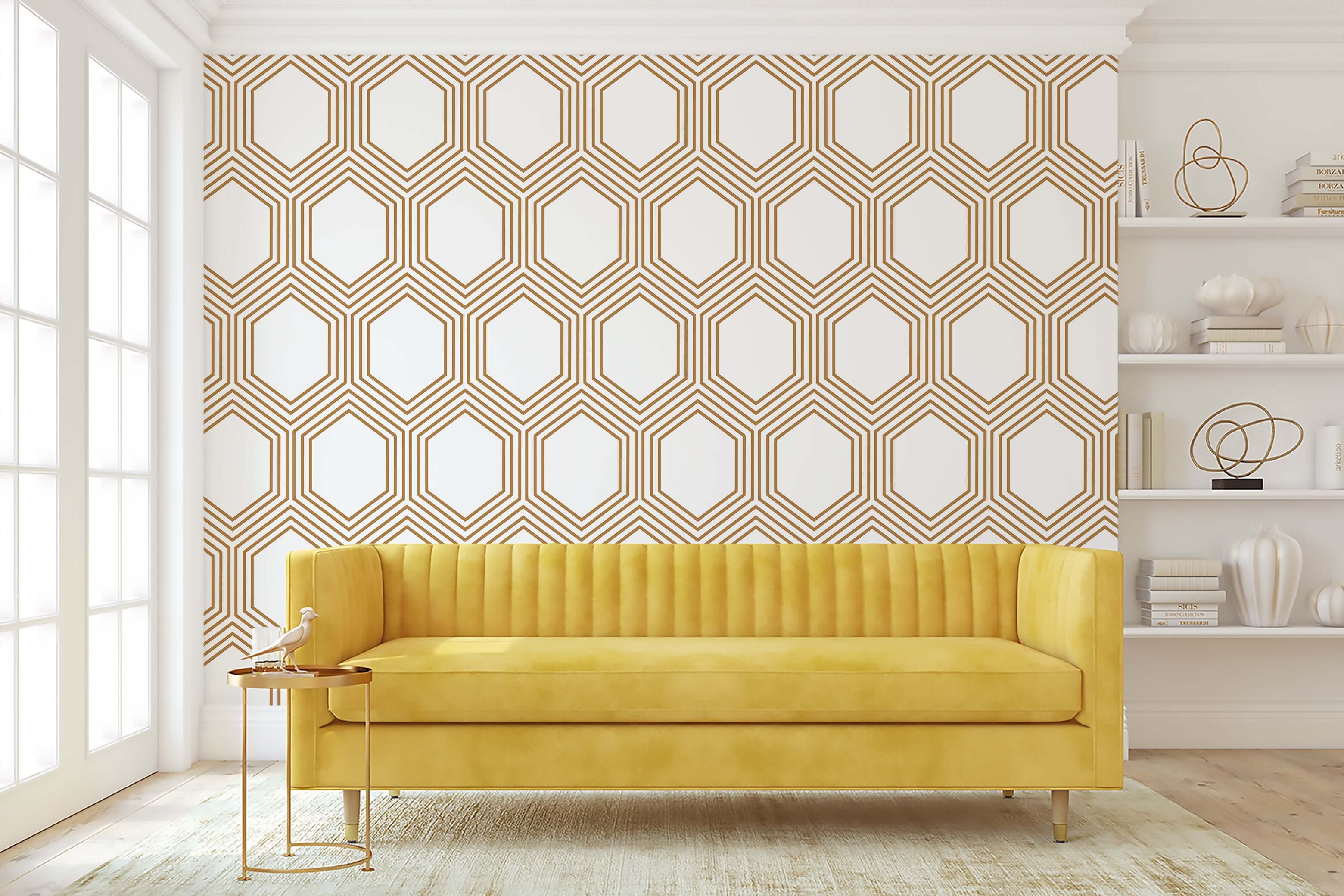 Art Deco geometric wallpaper with bronze hexagonal pattern on white, enhancing a modern living room with a yellow sofa.