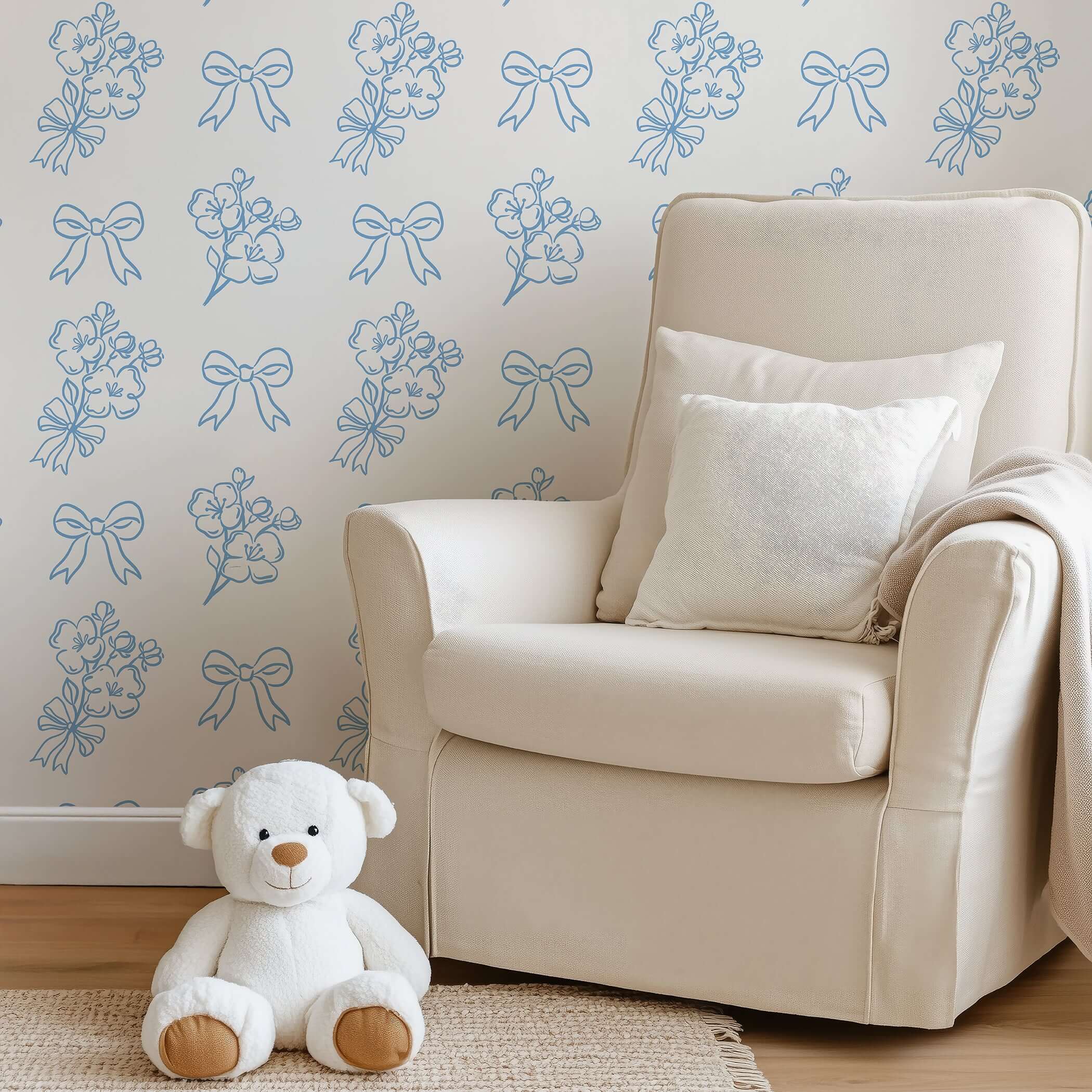 Elegant blue and white floral wallpaper with ribbons in cozy nursery, perfect for adding French charm and sophistication.