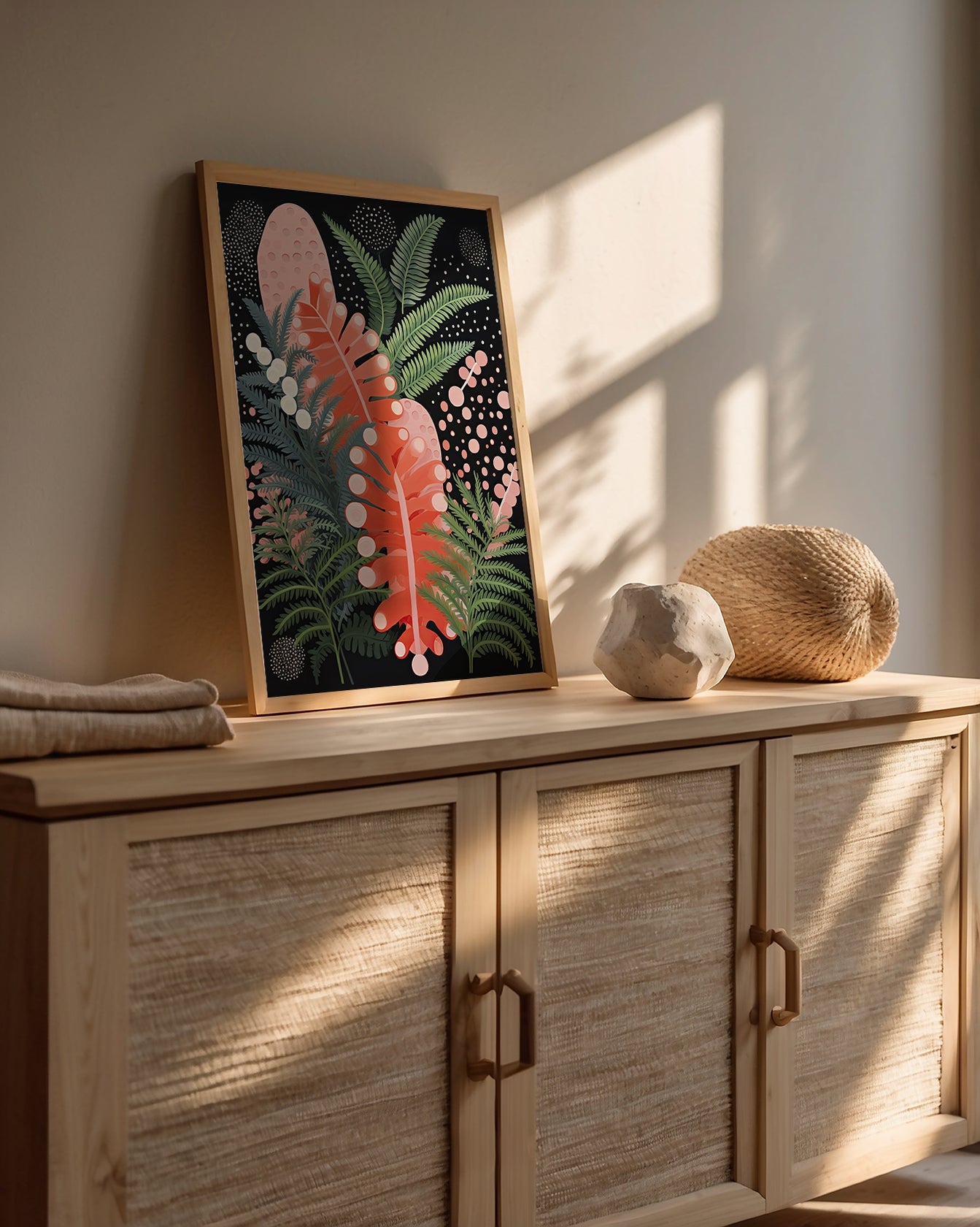 Abstract Jungle Glow wall art print featuring tropical leaves in a modern Bohemian style on a cabinet.