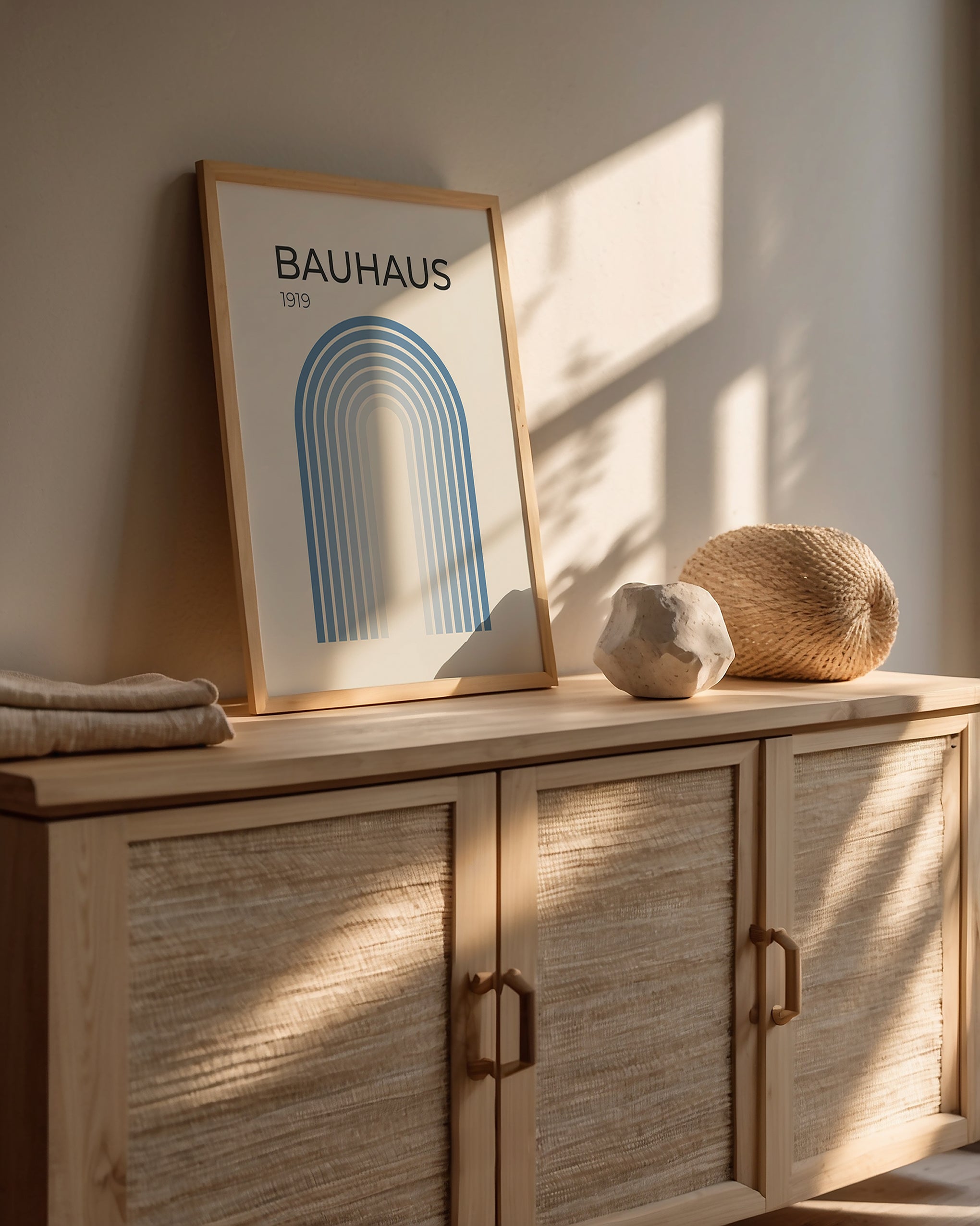 Bauhaus wall art print displayed on a wooden cabinet, showcasing modern design and minimalist decor.
