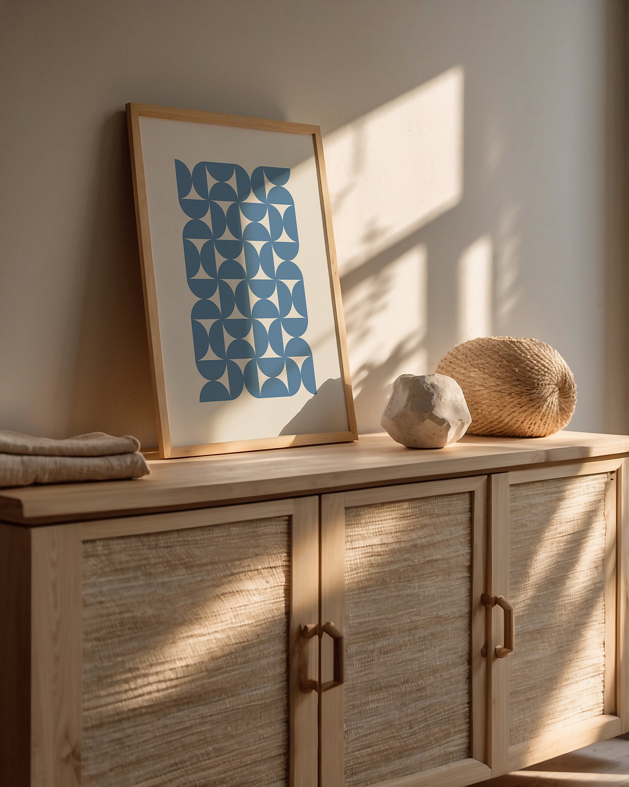 Bauhaus Waves art print featuring blue geometric patterns on a neutral wall, perfect for modern wall decor.