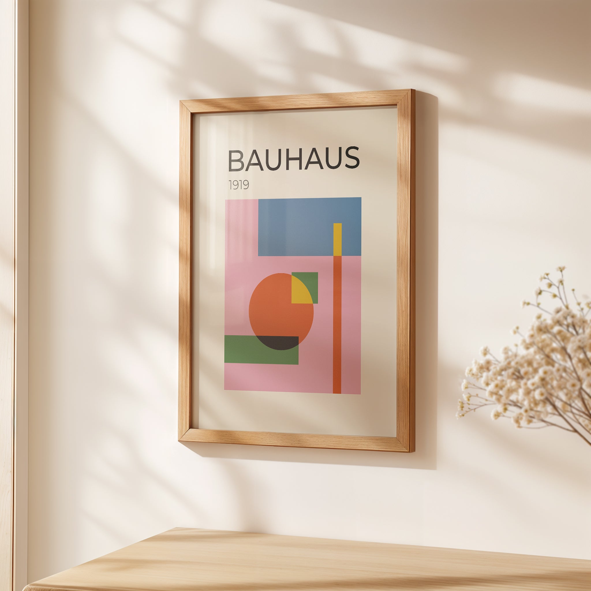 Bauhaus art print featuring geometric shapes in warm colors, framed and displayed on a wall for modern decor.