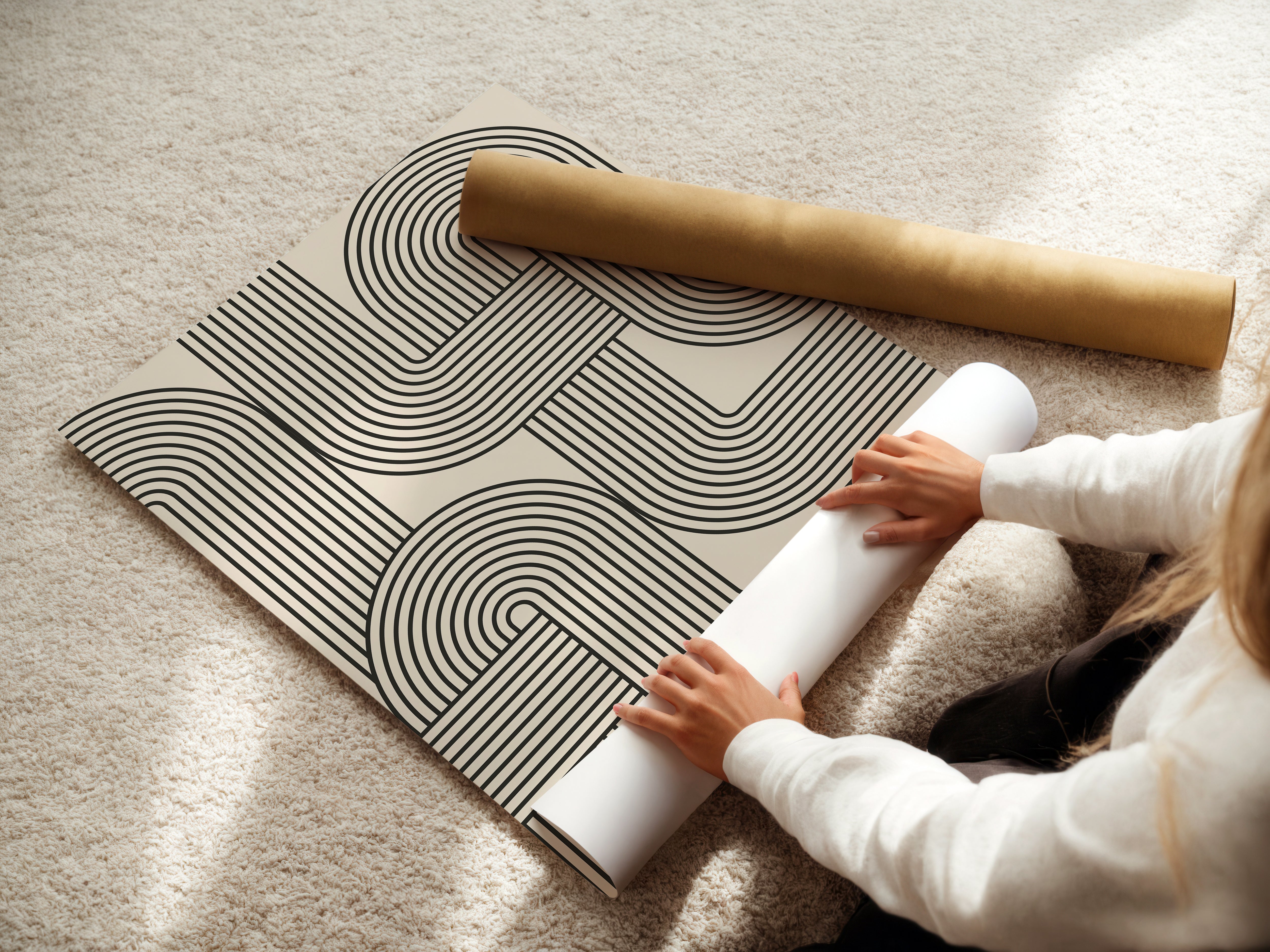 Person handling a Bauhaus-inspired wall art print with black lines and geometric design, perfect for modern decor.
