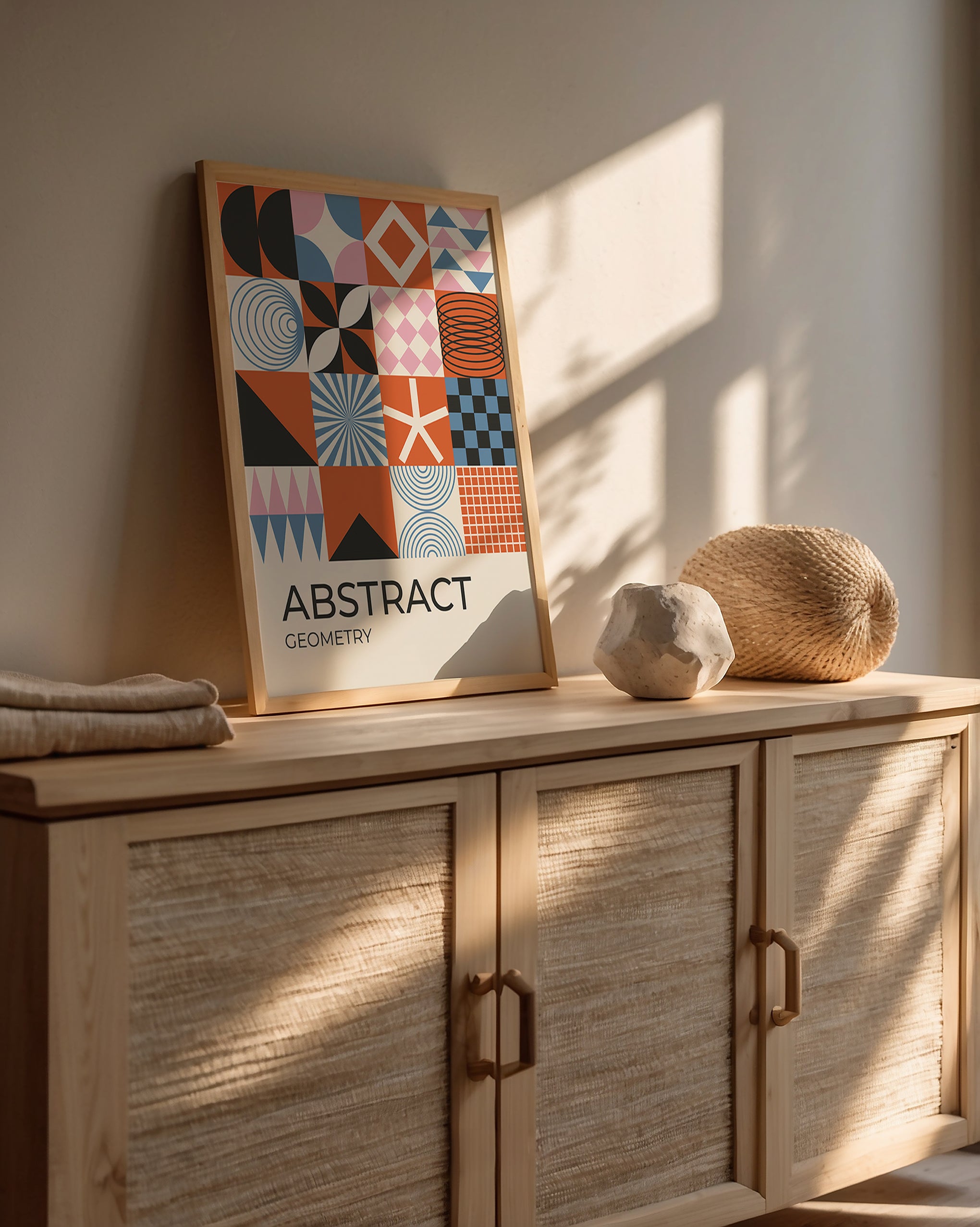 Modern color block art print featuring geometric shapes on a wooden cabinet with natural light.