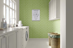 Laundry room with Spring Leaf wallpaper featuring abstract white leaves on green, perfect for a modern playroom or nursery design.
