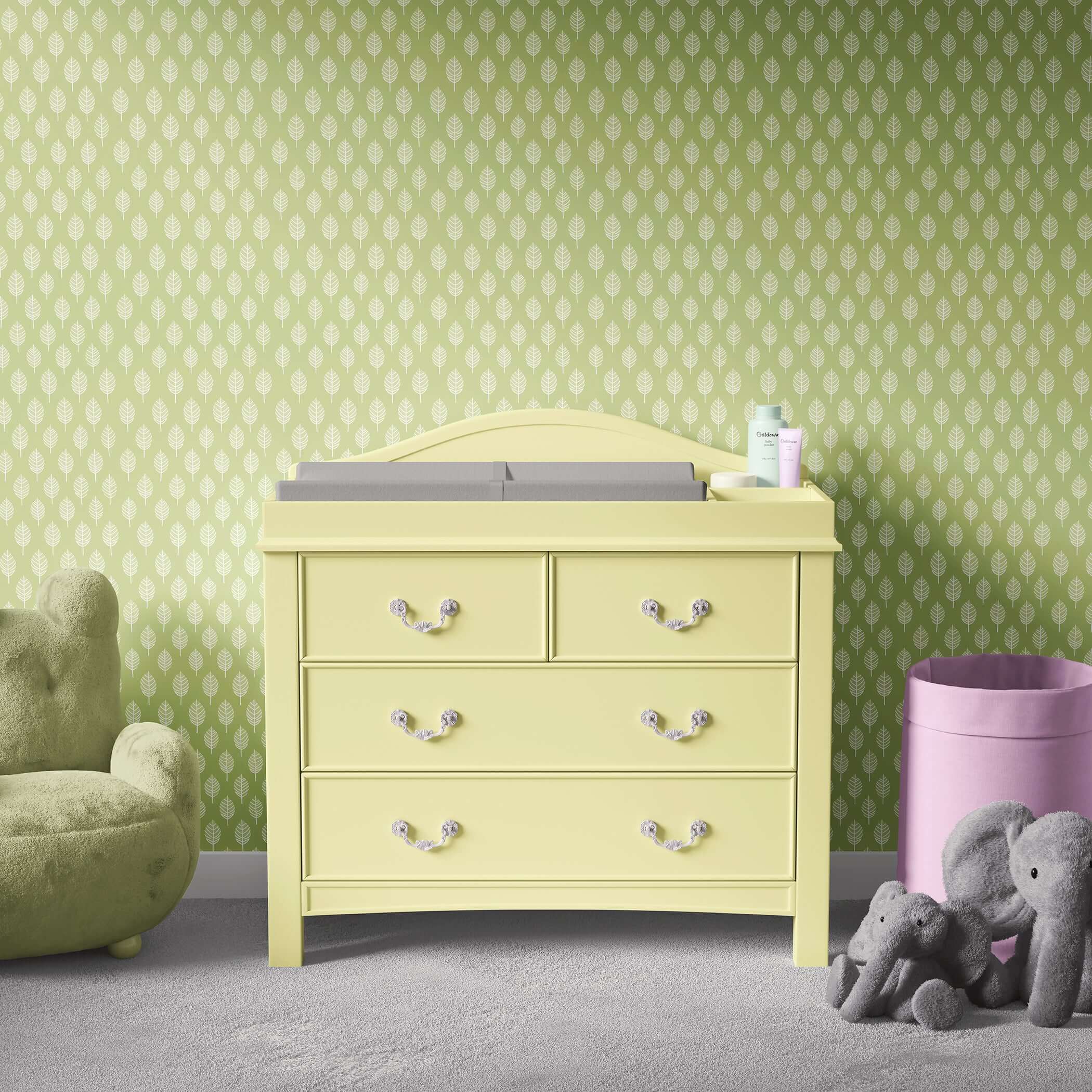 Modern nursery with abstract spring leaf wallpaper, yellow dresser, and plush toys, perfect for children's playroom elegance.