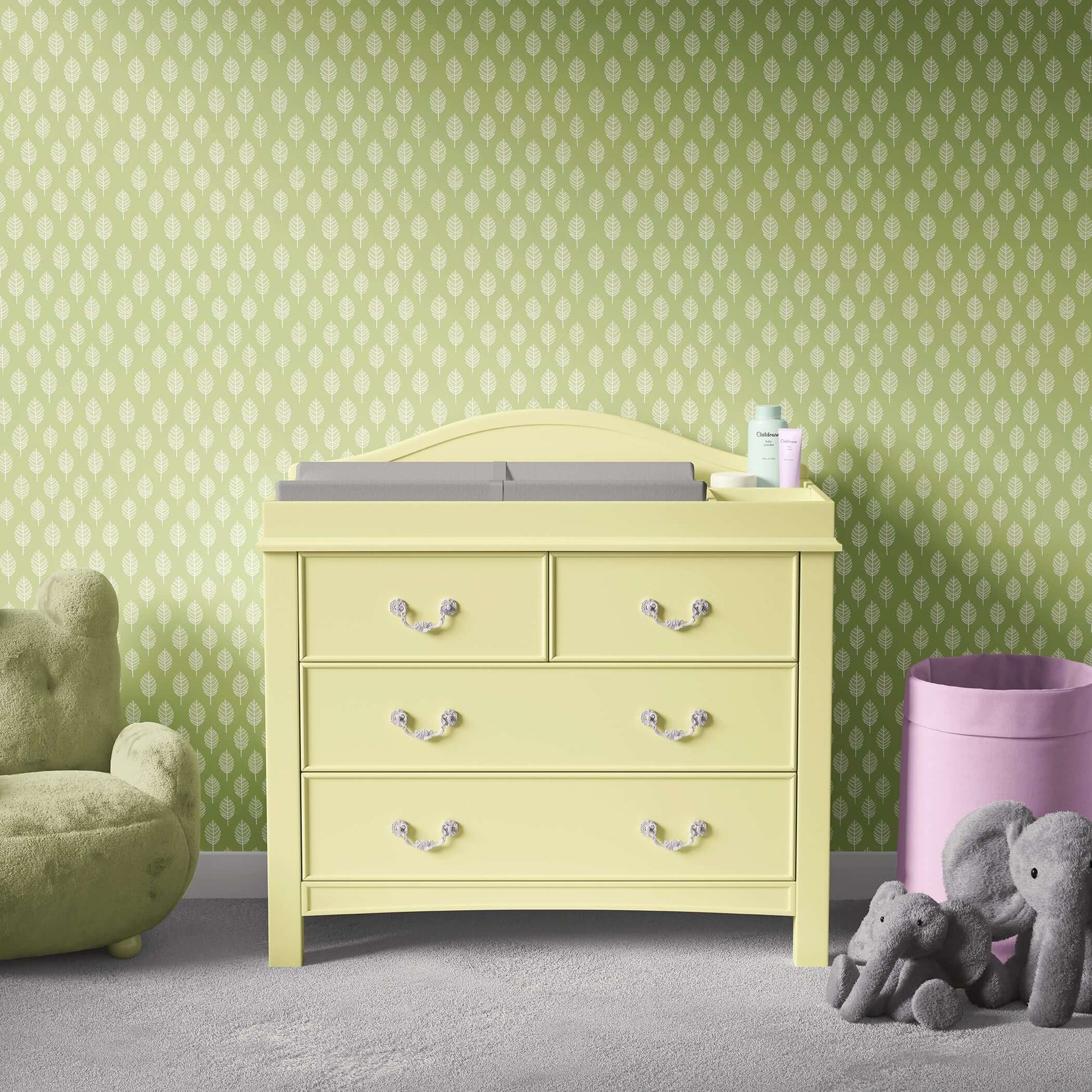 Modern nursery with abstract spring leaf wallpaper, yellow dresser, and plush toys, perfect for children's playroom elegance.