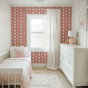 Petal Pink Wallpaper in nursery, featuring white leaf patterns on coral-pink background, ideal for modern children's playroom design.