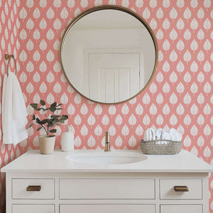 Spring Blush botanical wallpaper with white leaves on a blush-pink background, perfect for modern design in a nursery or playroom.