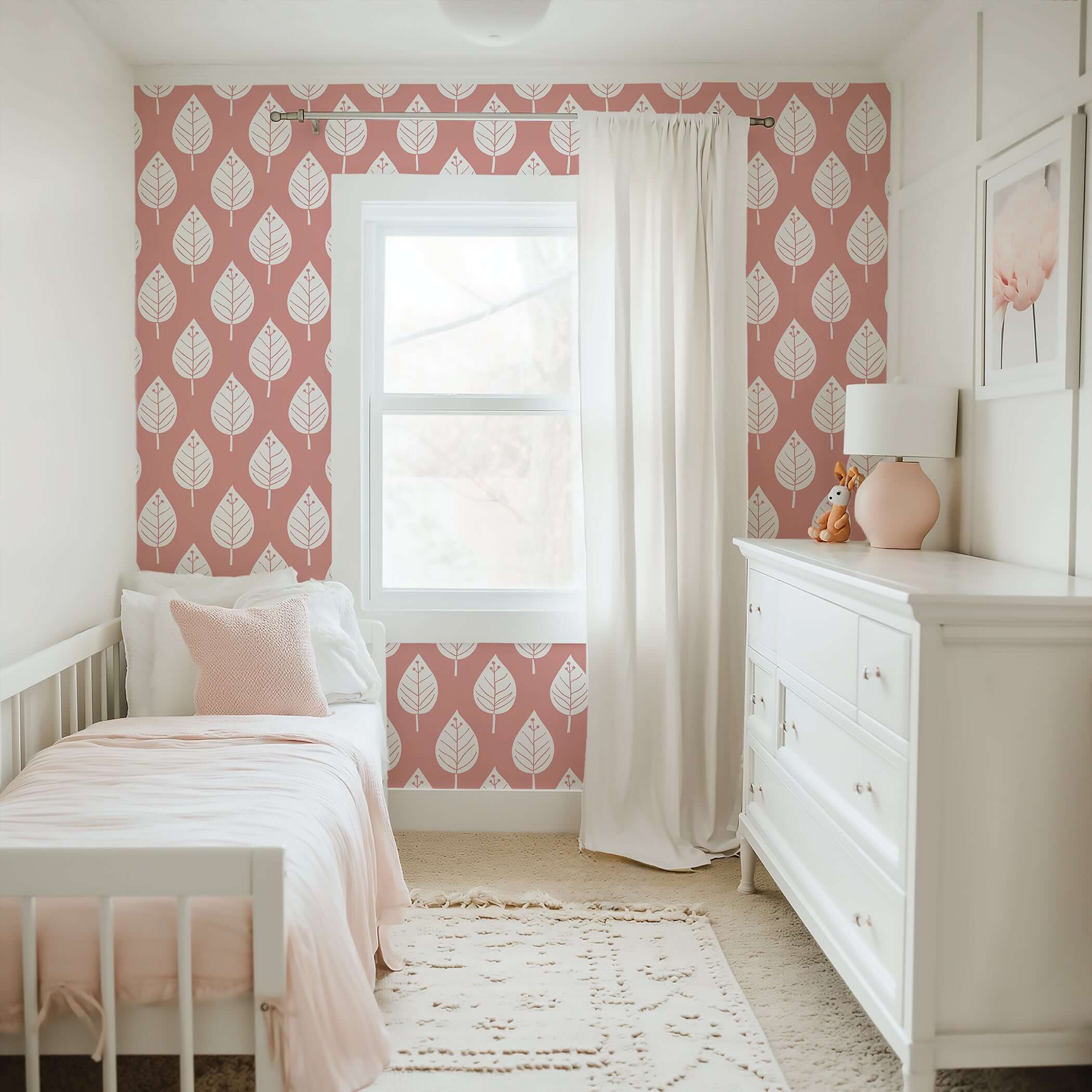 Modern nursery with Spring Blush wallpaper featuring white leaves on a pink background, perfect for children's rooms and playrooms.