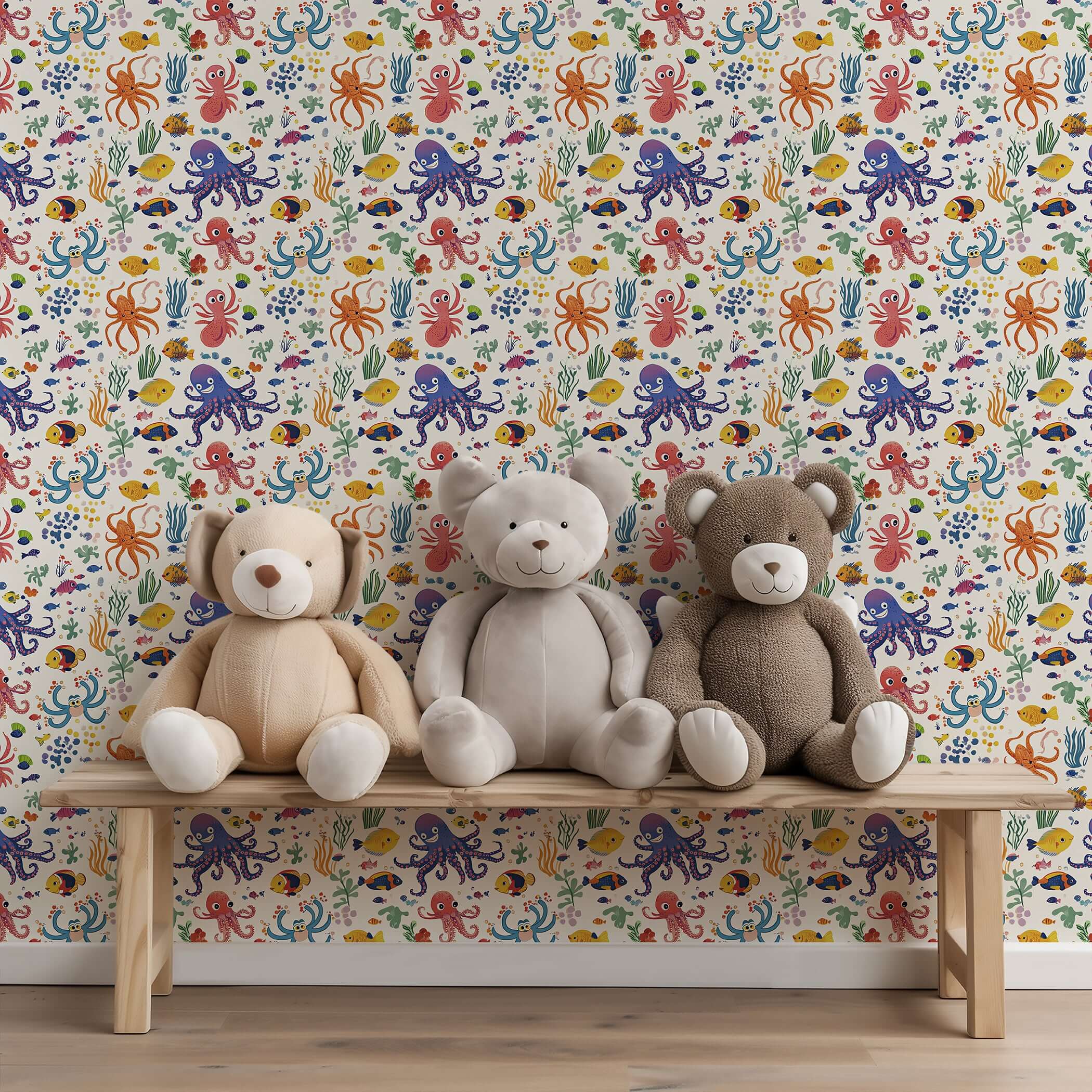 Colorful Reef Buddies wallpaper with octopus and fish in a nursery playroom, featuring plush teddy bears on a bench.