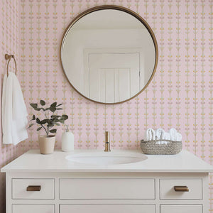 Luxurious Sugar Blossom Luxe Floral wallpaper in a bathroom, featuring pink background and gold florals for nursery or playroom elegance.
