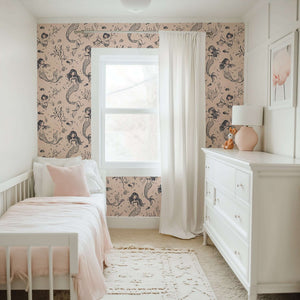Mermaid Dreams wallpaper in a nursery with mermaids, seashells, blush tones, and coastal charm. Ideal for ocean-themed children’s spaces.