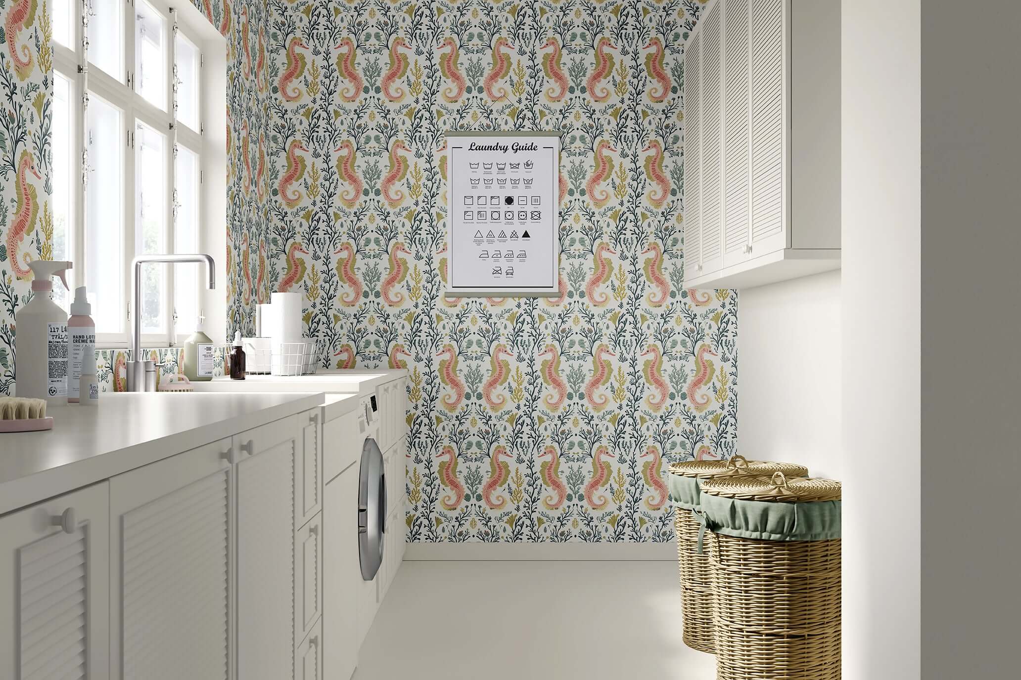 Coastal elegance with "Tidal Bloom" wallpaper featuring seahorses and seaweed in soothing pink, sage, and gold tones in a laundry room.