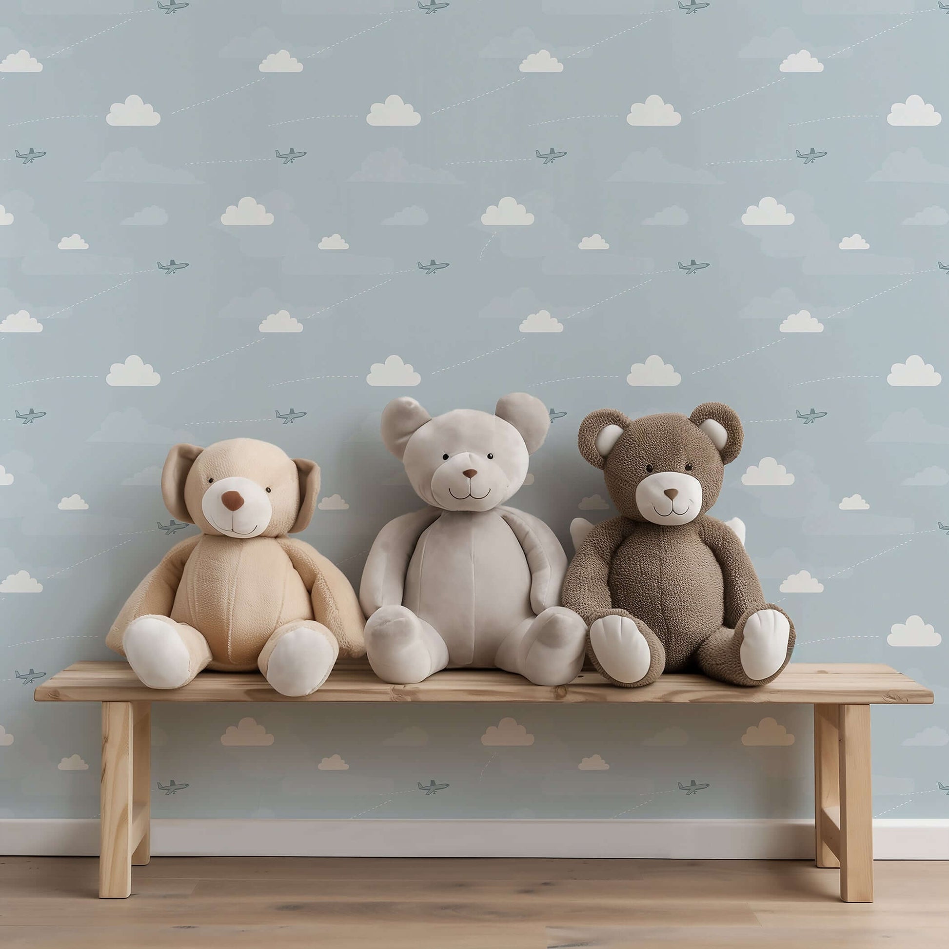 Flying High Wallpaper with airplanes and clouds in a children's nursery, featuring plush teddy bears on a wooden bench.