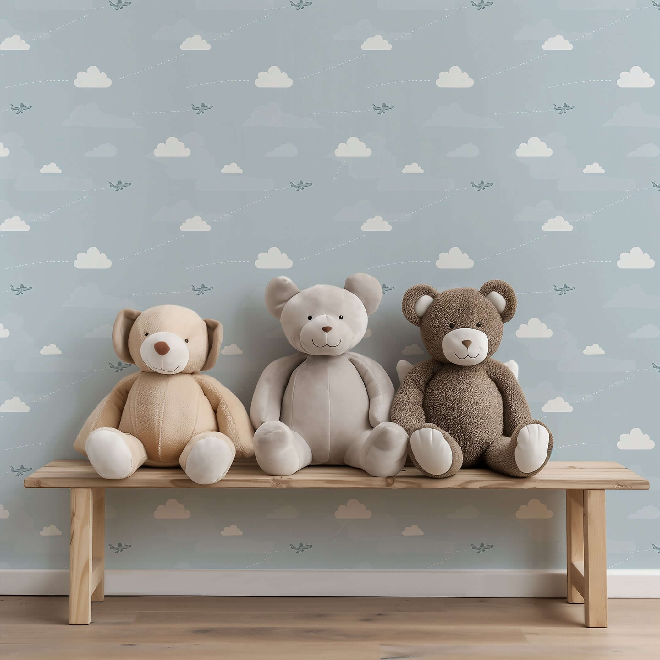 Flying High Wallpaper with airplanes and clouds in a children's nursery, featuring plush teddy bears on a wooden bench.