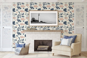 Living room with Fishy Florals wallpaper featuring blush fish and navy foliage, creating a coastal ambiance with a lighthouse art centerpiece.
