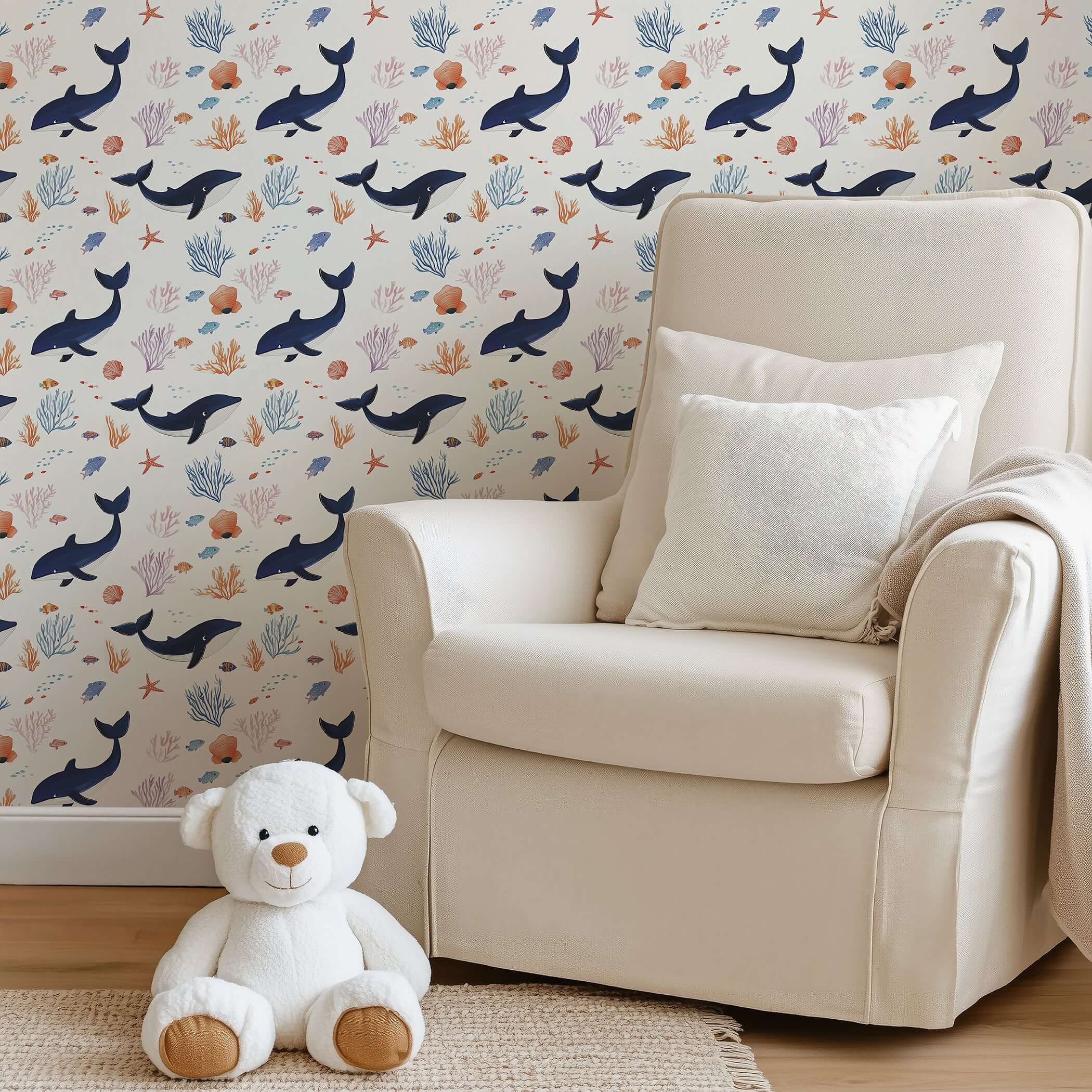Coastal-themed nursery with Whale of a Time wallpaper featuring whales, coral, and ocean scenes for a playful touch.