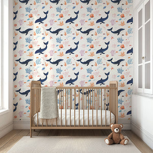 Dreamy coastal nursery with "Whale of a Time" wallpaper featuring whimsical whales, coral, and seaweed. Perfect for ocean-themed rooms.